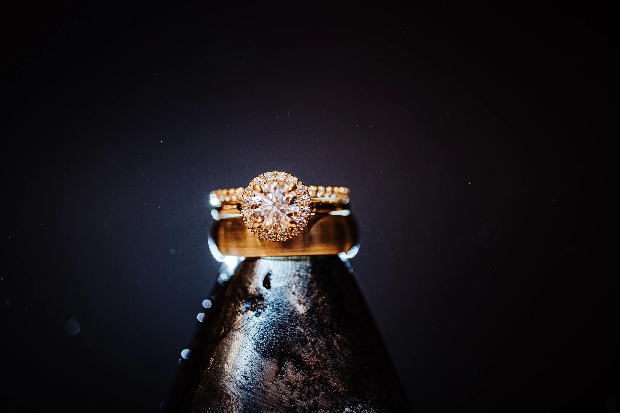 Wedding Details: their rings stacked on a bottle top at a wedding at the Omni Hotel at The Battery in Atlanta, GA