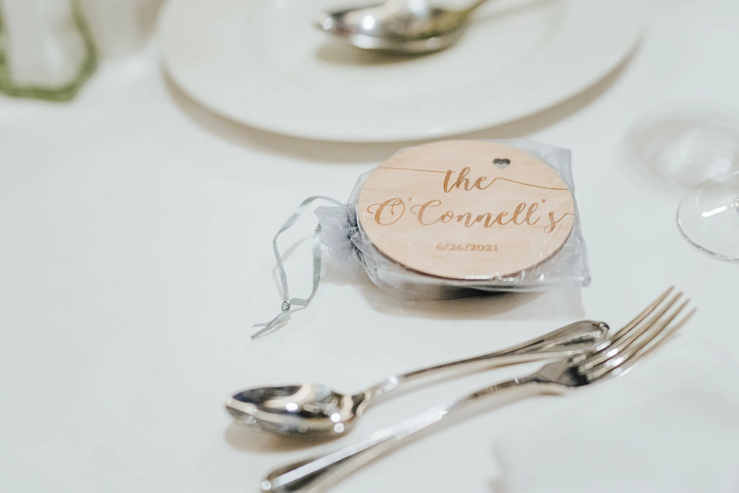Reception Details: a wood coaster favor with their name at a wedding at the Omni Hotel at The Battery in Atlanta, GA