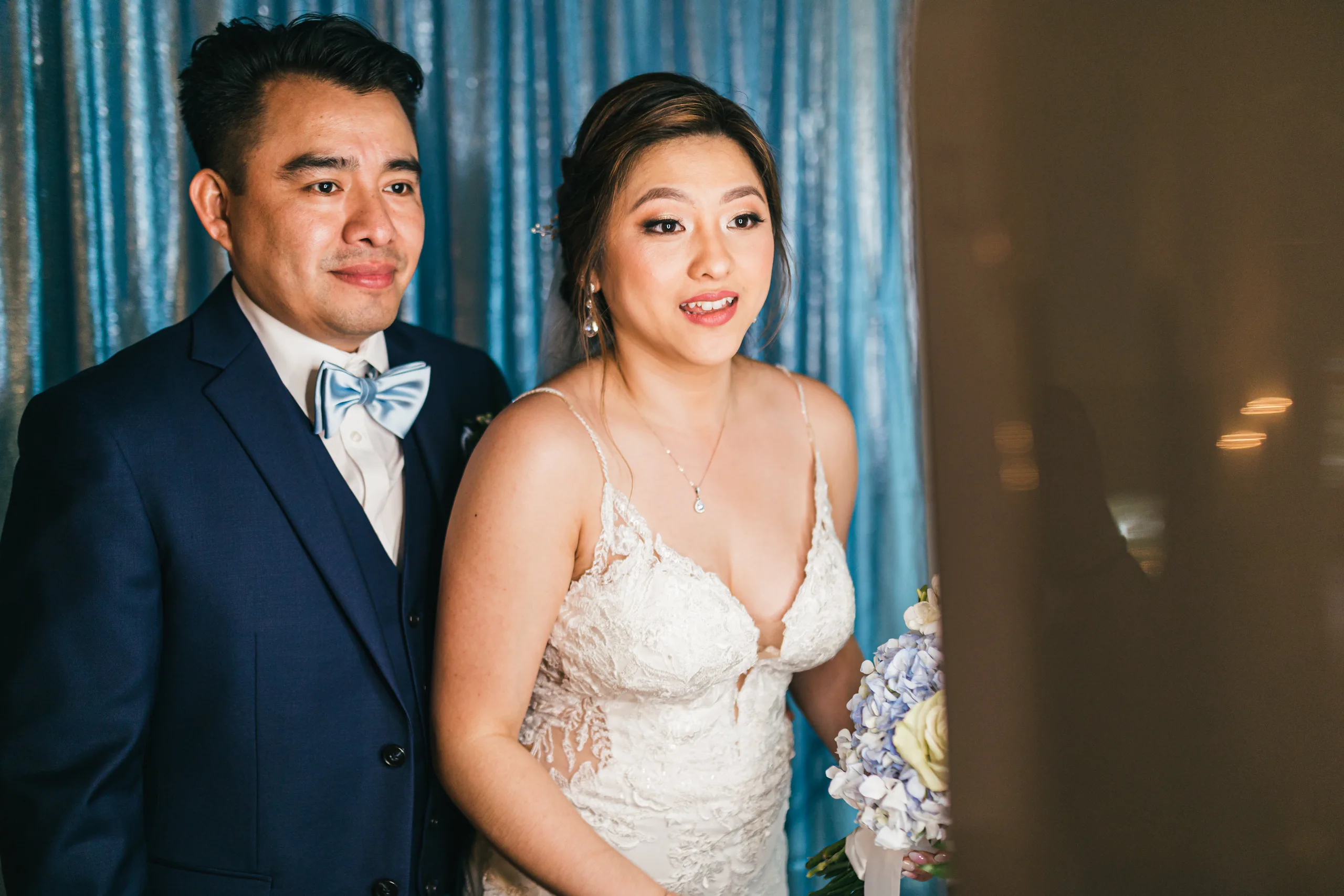 Reception: the grand entrance in front of the blue curtain at their wedding at the Payne-Corley House in Duluth, GA