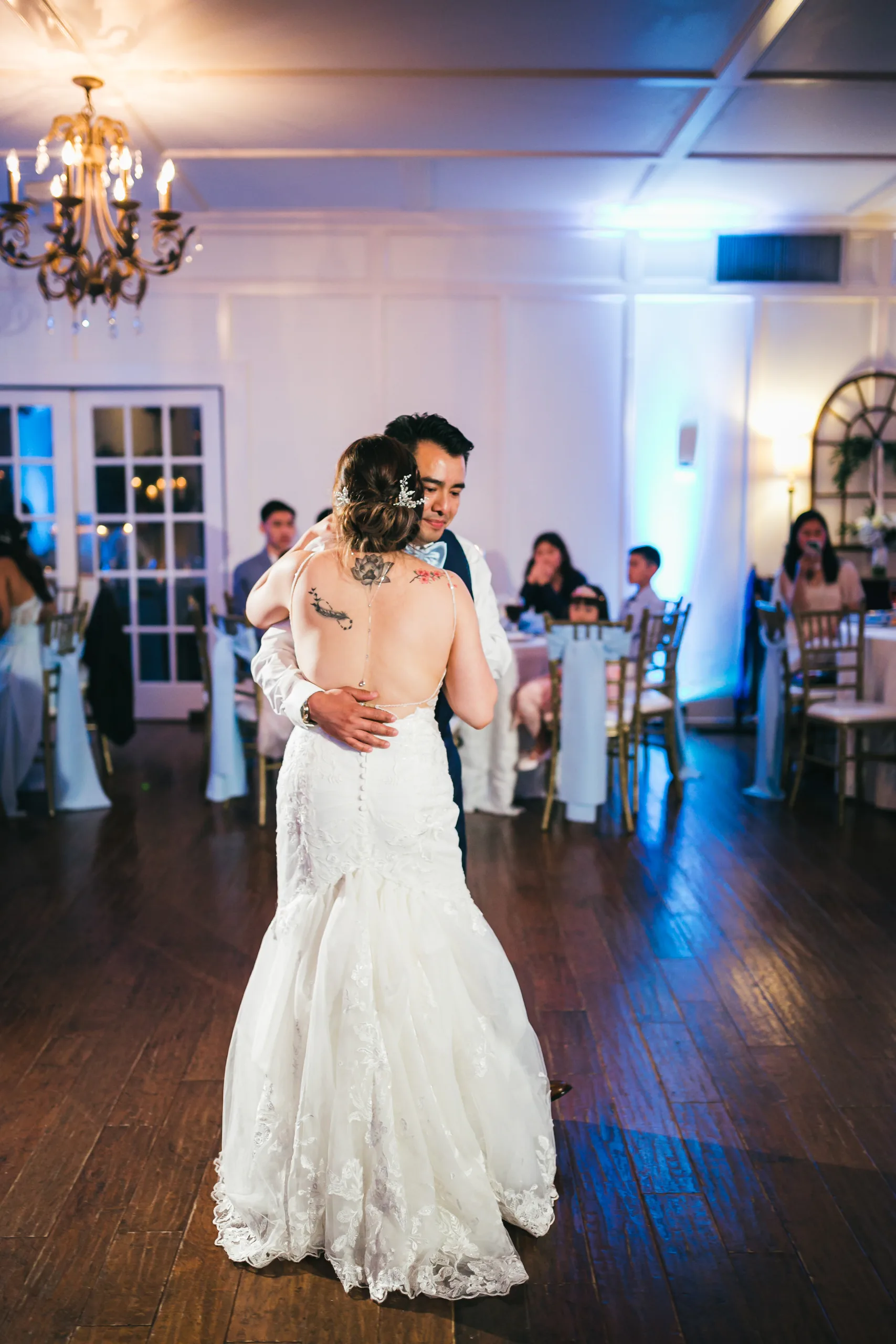 First Dance: dancing under the chandelier at their wedding at the Payne-Corley House in Duluth, GA