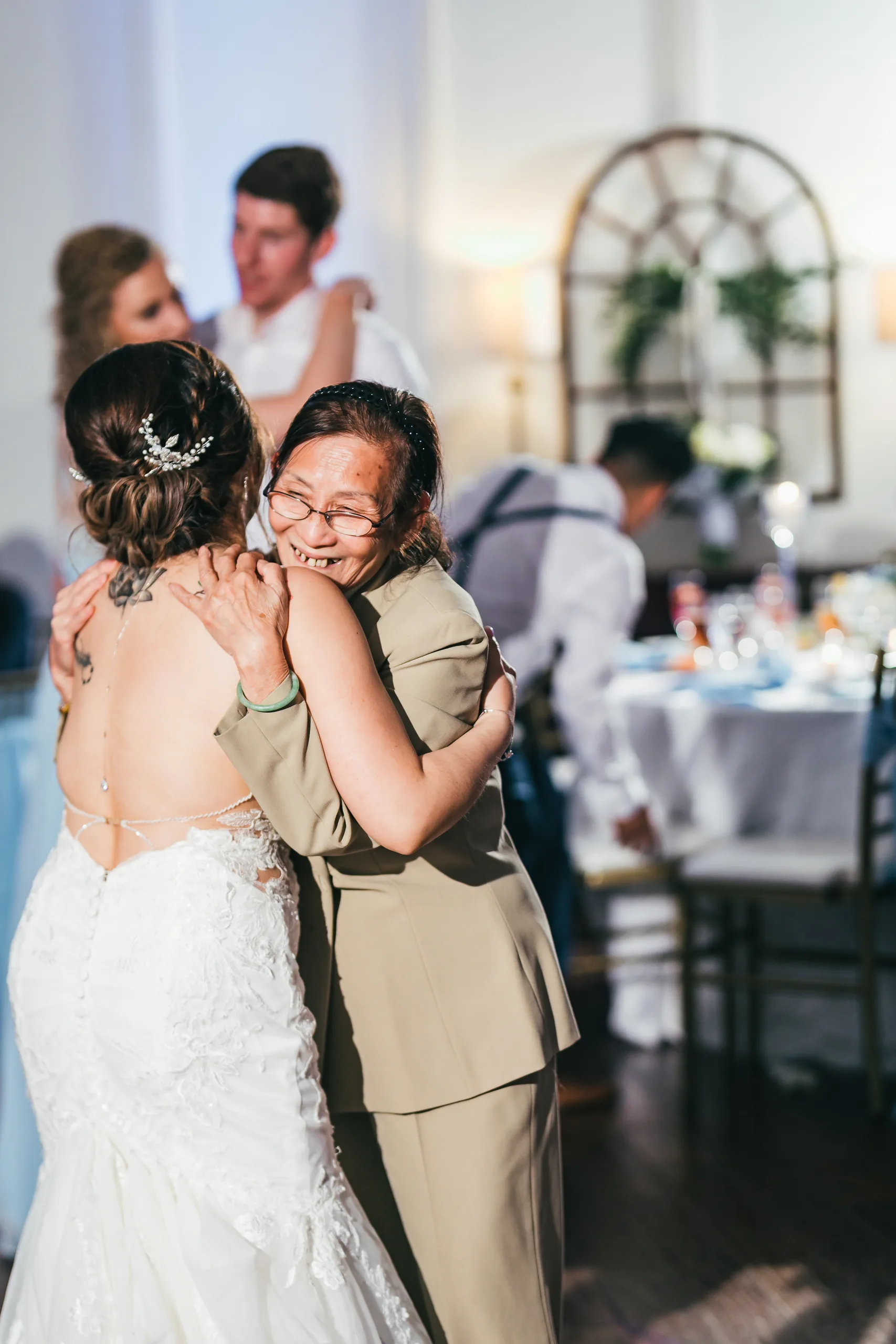 Reception: the bride hugging her mother on the dance floor at their wedding at the Payne-Corley House in Duluth, GA