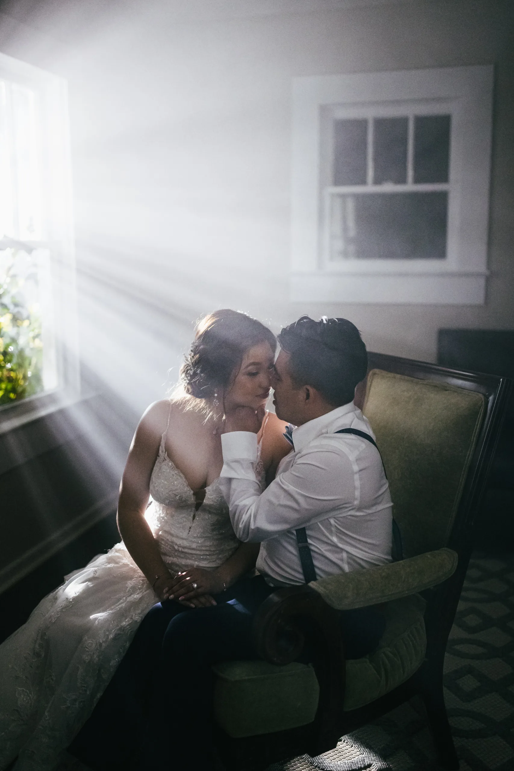 Night Portraits: a kiss in the window light at their wedding at the Payne-Corley House in Duluth, GA