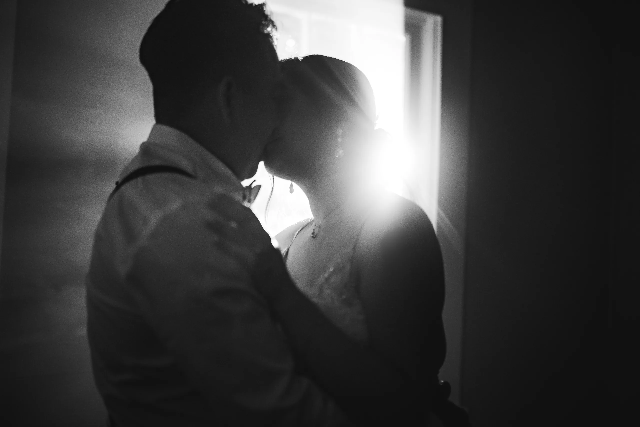 Night Portraits: a silhouette kiss in the doorway, in black and white at their wedding at the Payne-Corley House in Duluth, GA