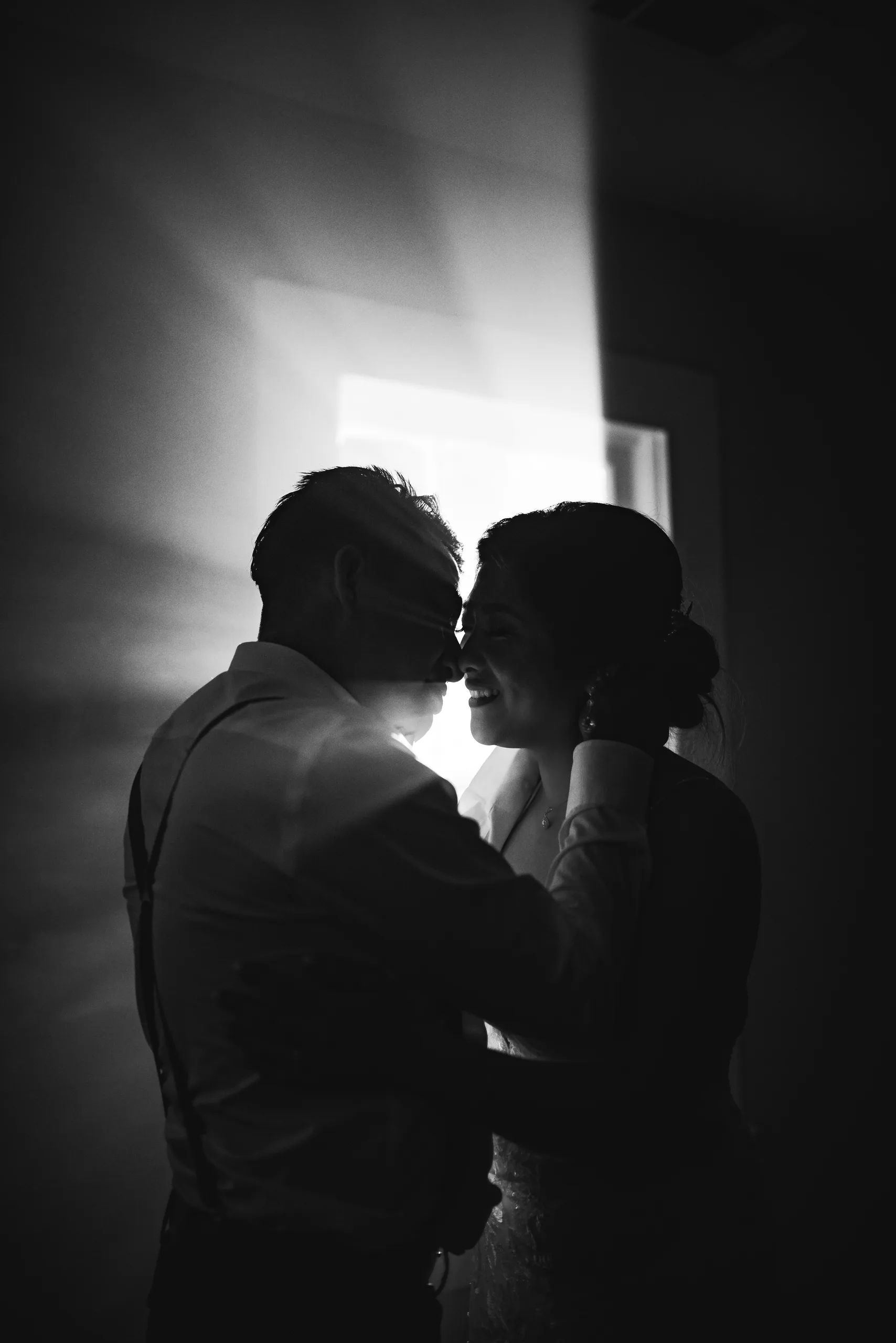 Night Portraits: forehead to forehead in the doorway light, in black and white at their wedding at the Payne-Corley House in Duluth, GA