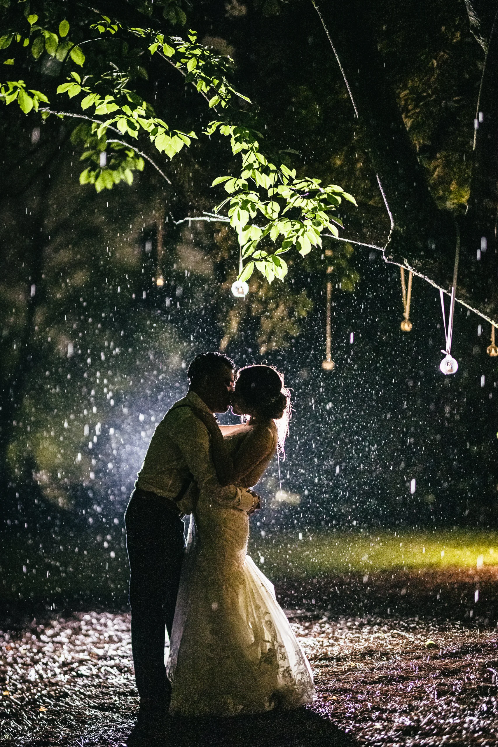 Night Portraits: a kiss under the lit trees at night at their wedding at the Payne-Corley House in Duluth, GA