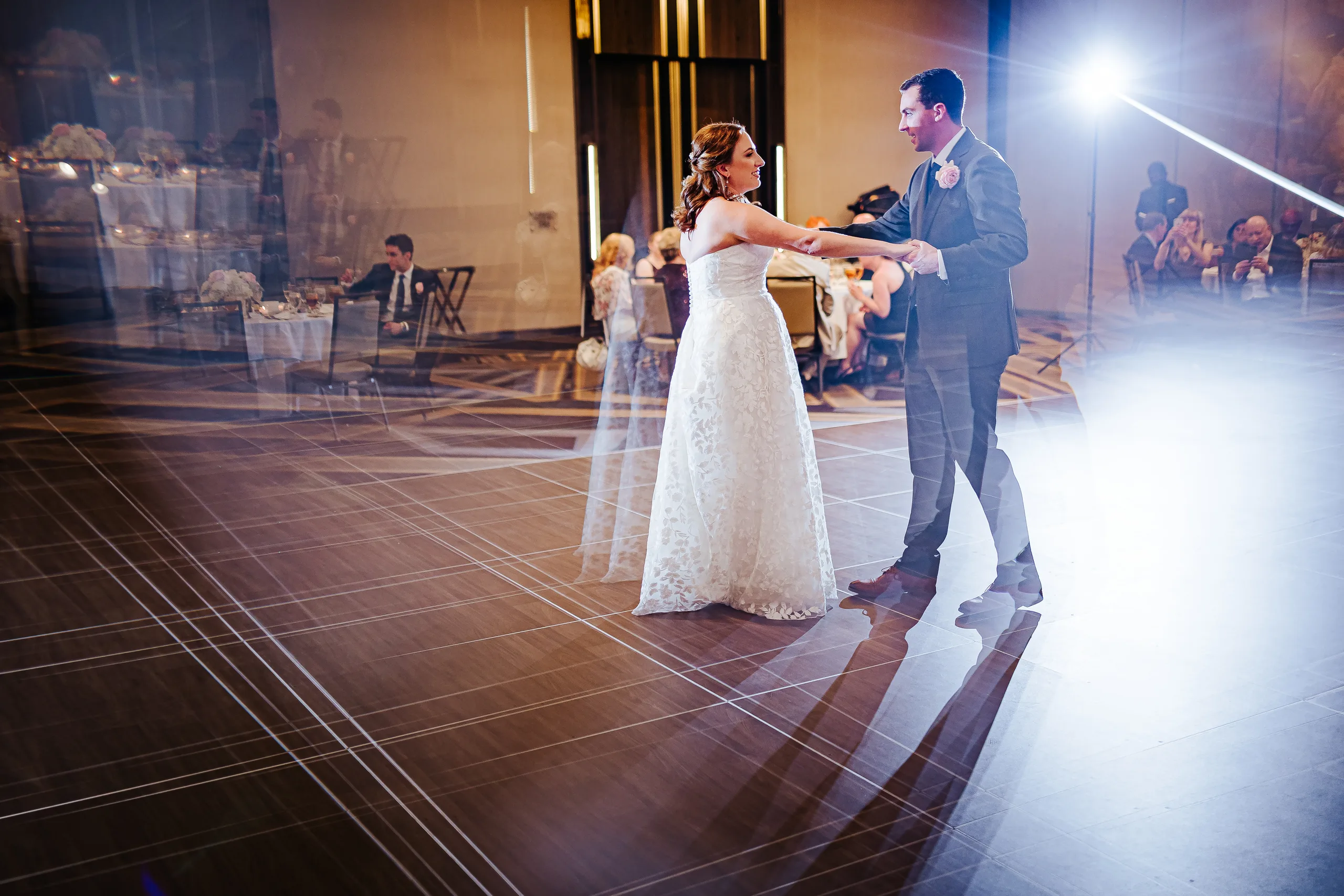 First Dance: dancing under the lights in the ballroom at their wedding at the Omni Hotel at The Battery in Atlanta, GA