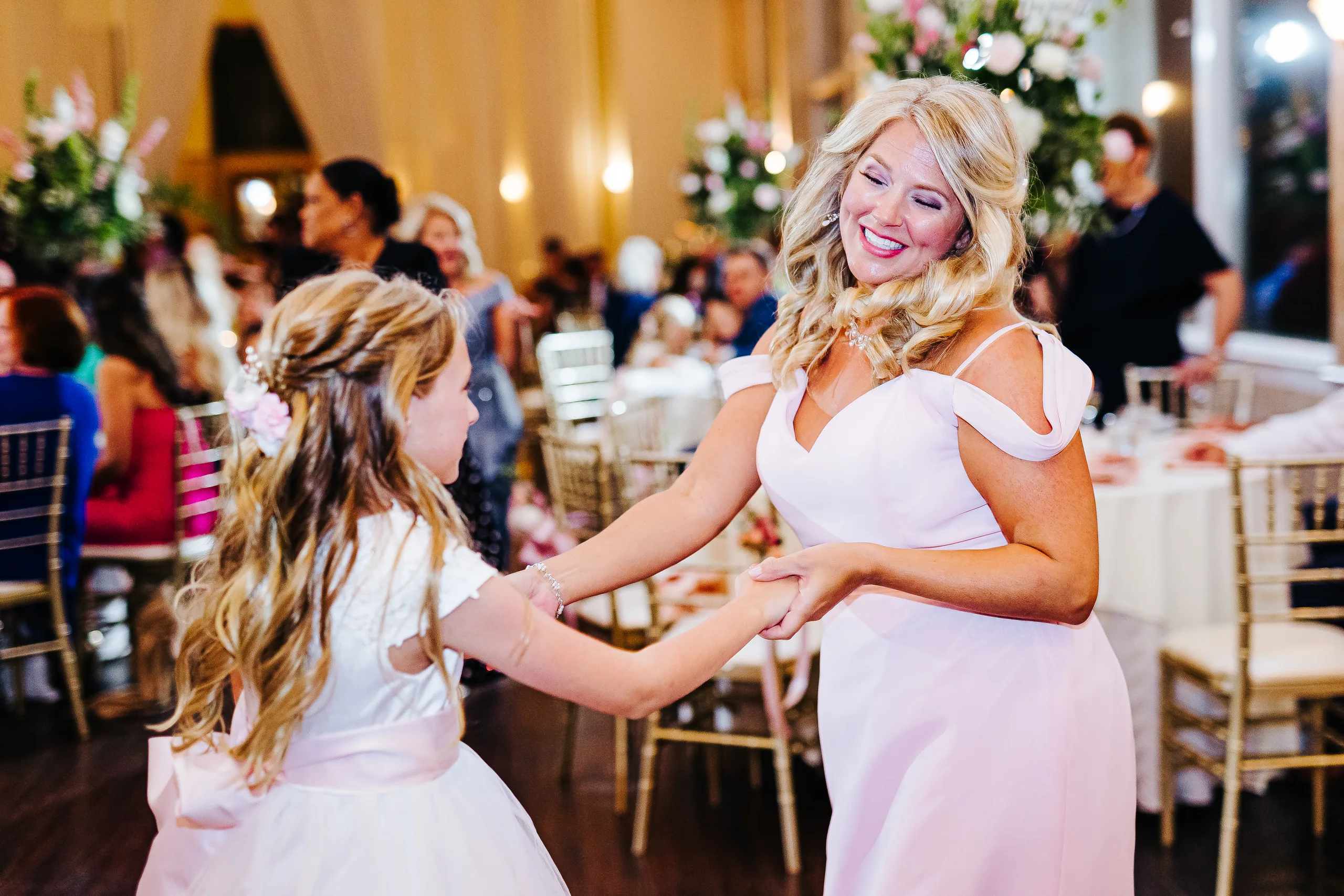 Reception: a bridesmaid dancing with a flower girl, at their wedding at The Piedmont Room in Atlanta, GA