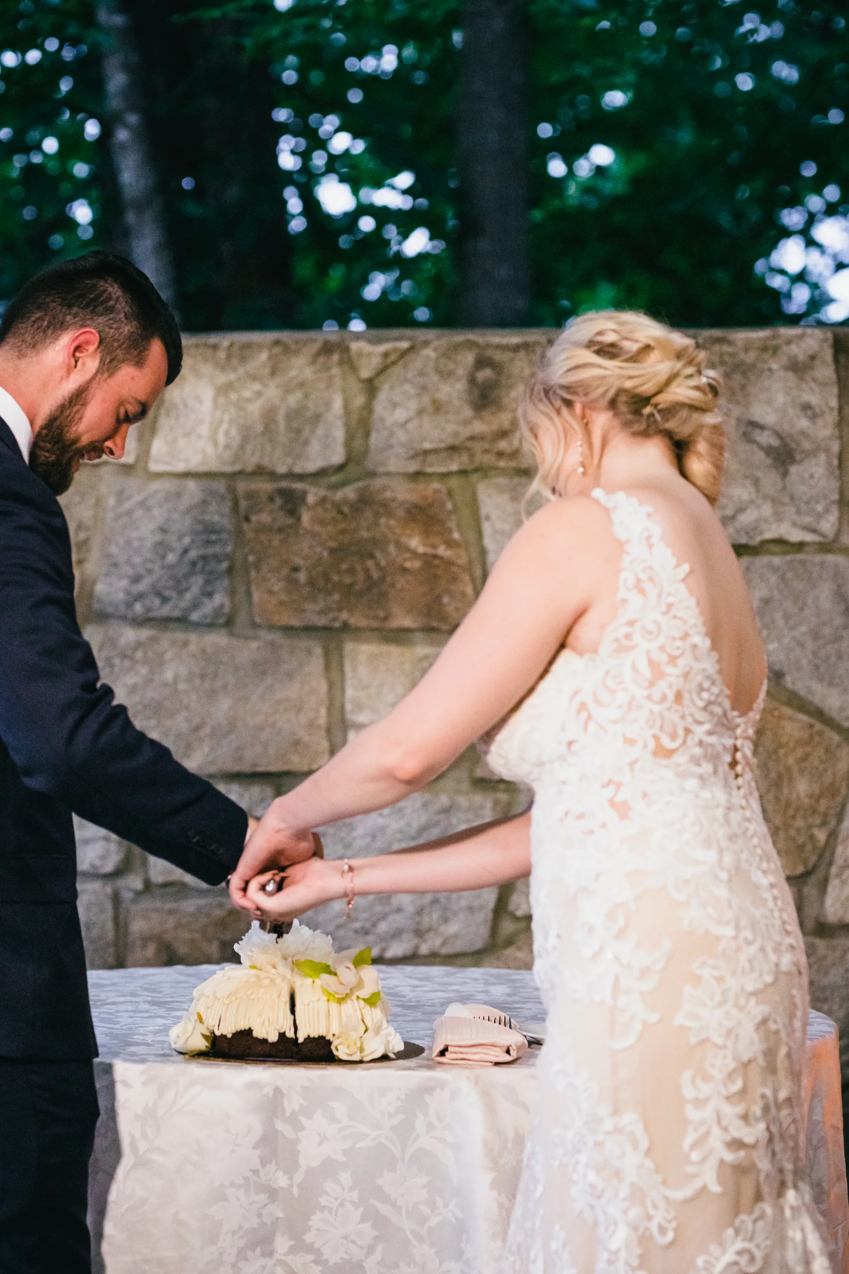 Reception: cutting the cake together, at their wedding at Atlanta Evergreen Lakeside Resort in Stone Mountain, GA