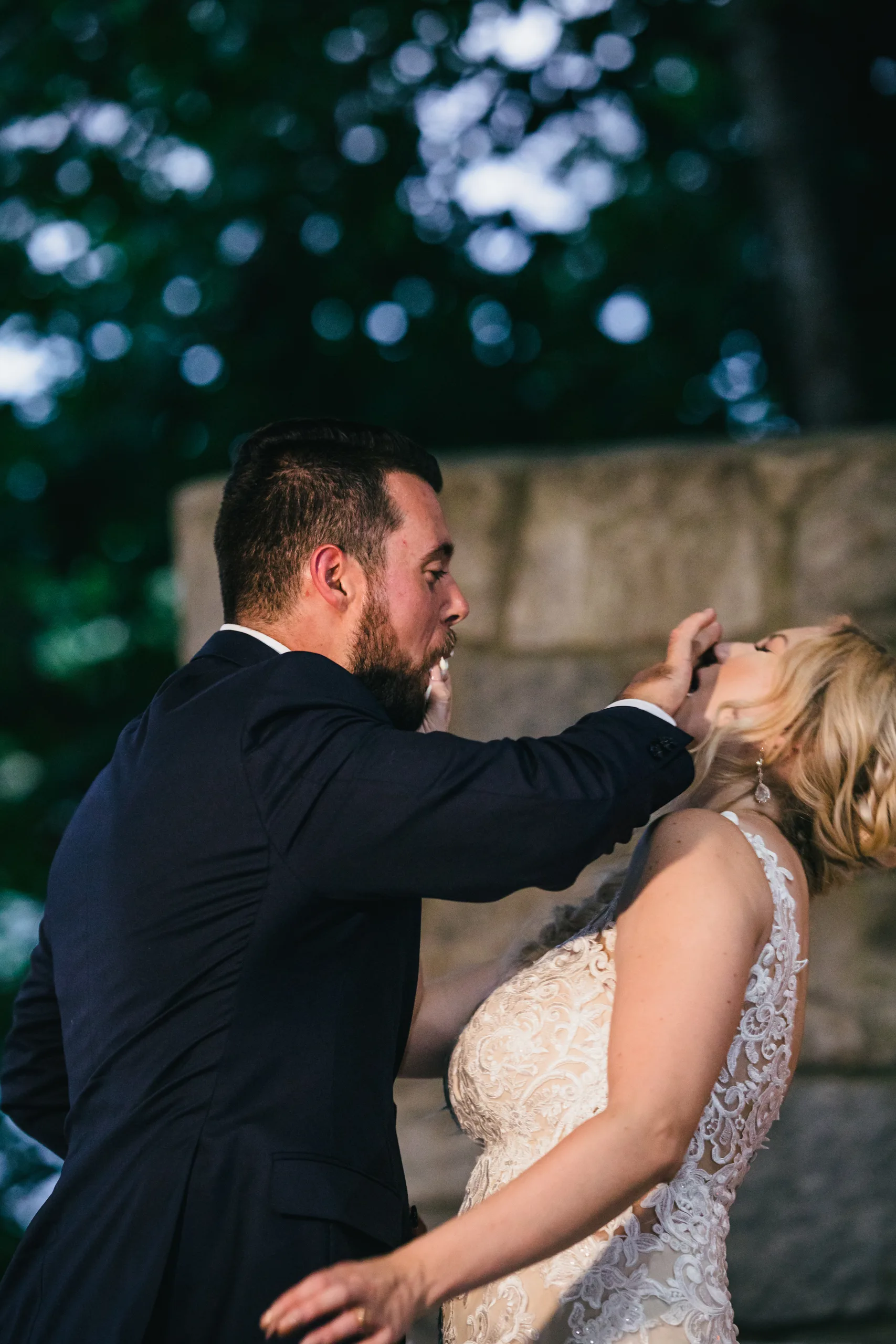 Reception: feeding each other cake, at their wedding at Atlanta Evergreen Lakeside Resort in Stone Mountain, GA