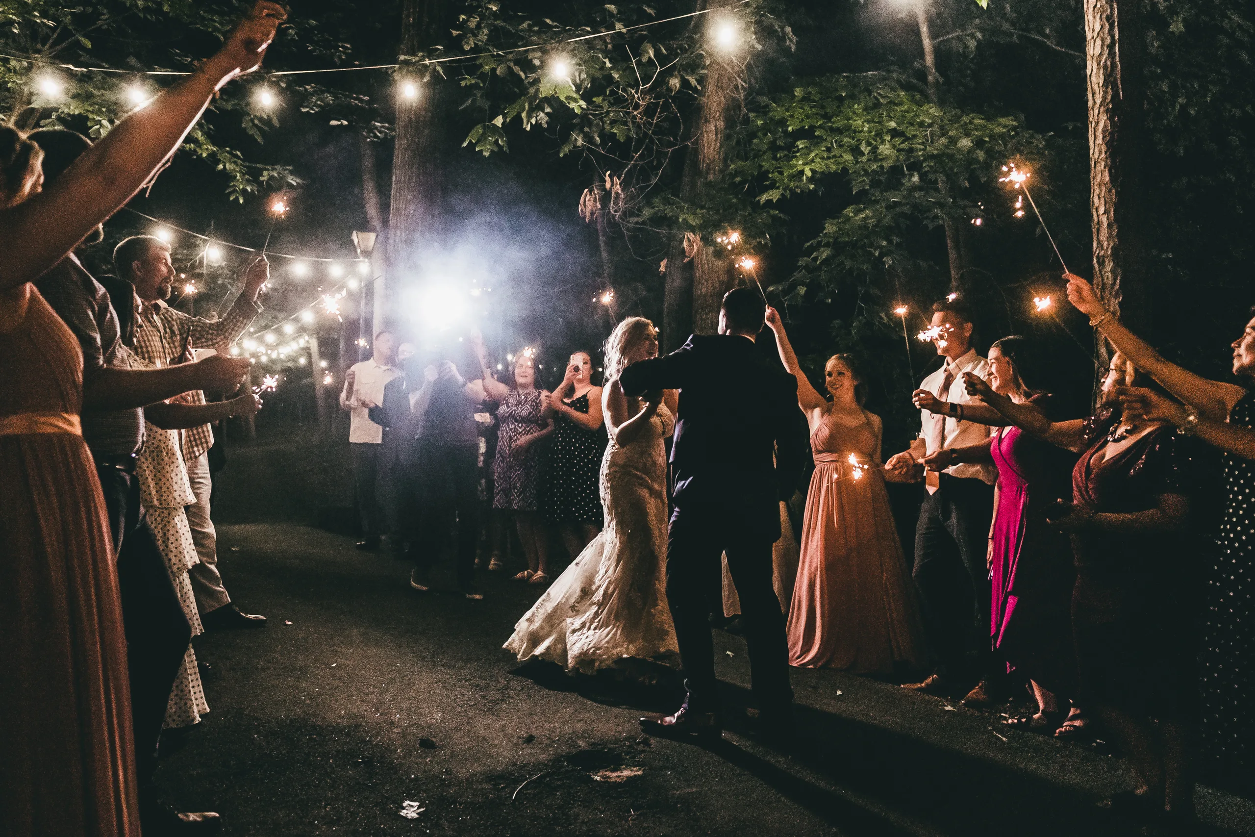 Send-Off: walking out through a tunnel of sparklers, at their wedding at Atlanta Evergreen Lakeside Resort in Stone Mountain, GA