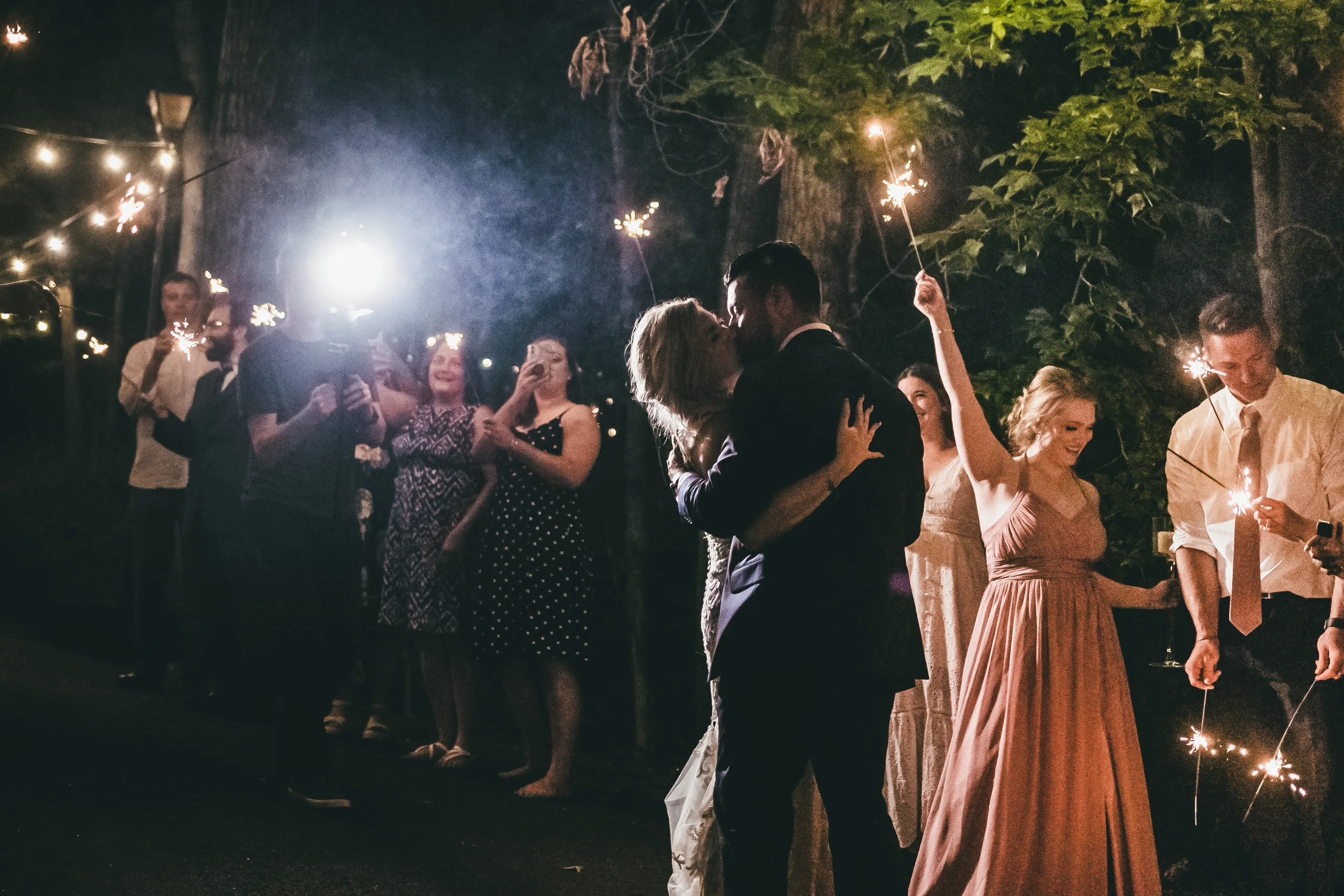 Send-Off: a kiss between the sparklers, at their wedding at Atlanta Evergreen Lakeside Resort in Stone Mountain, GA