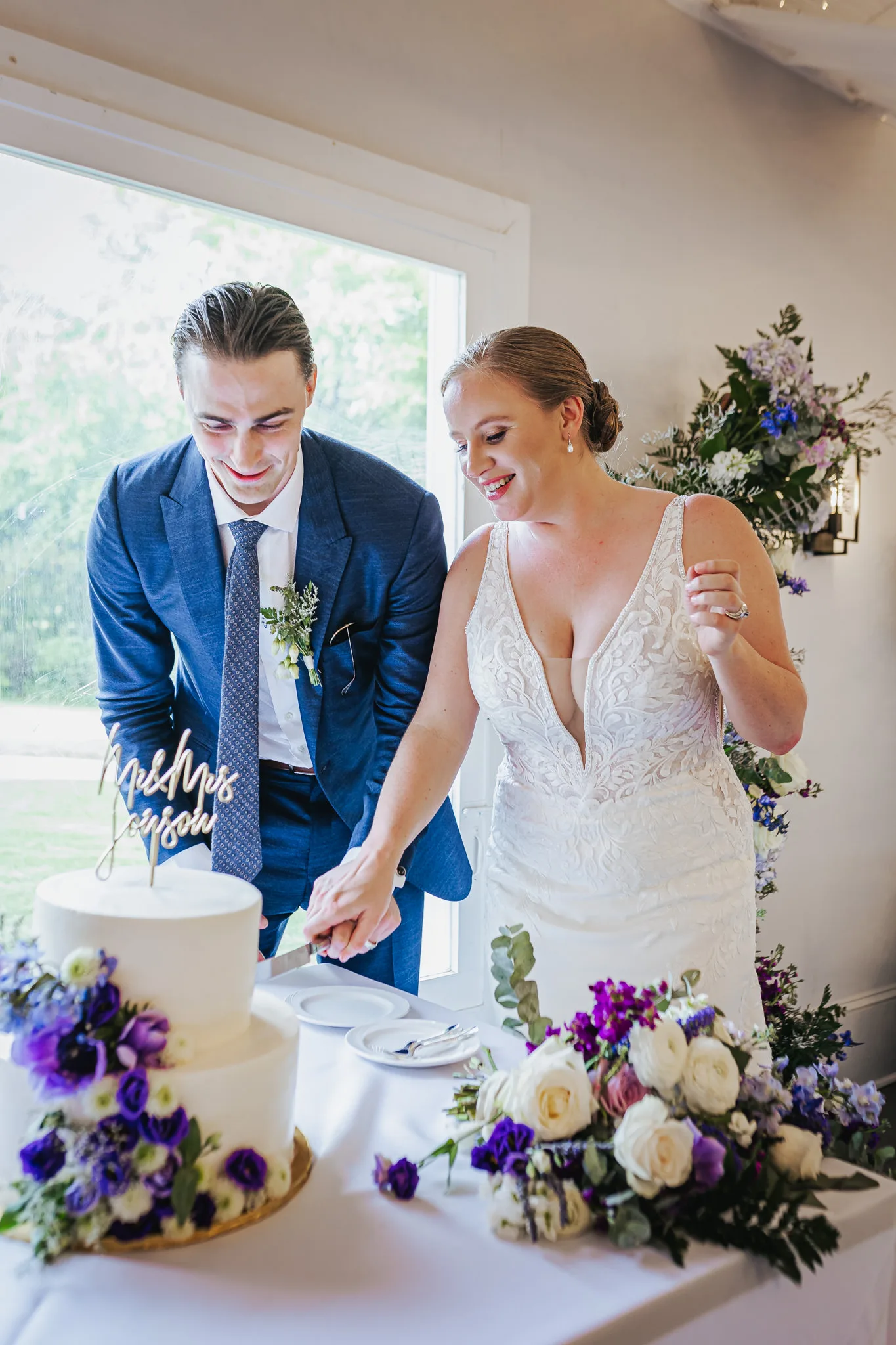 Reception: cutting the cake together, at their wedding at The Wildflower 301 in Greensboro, GA