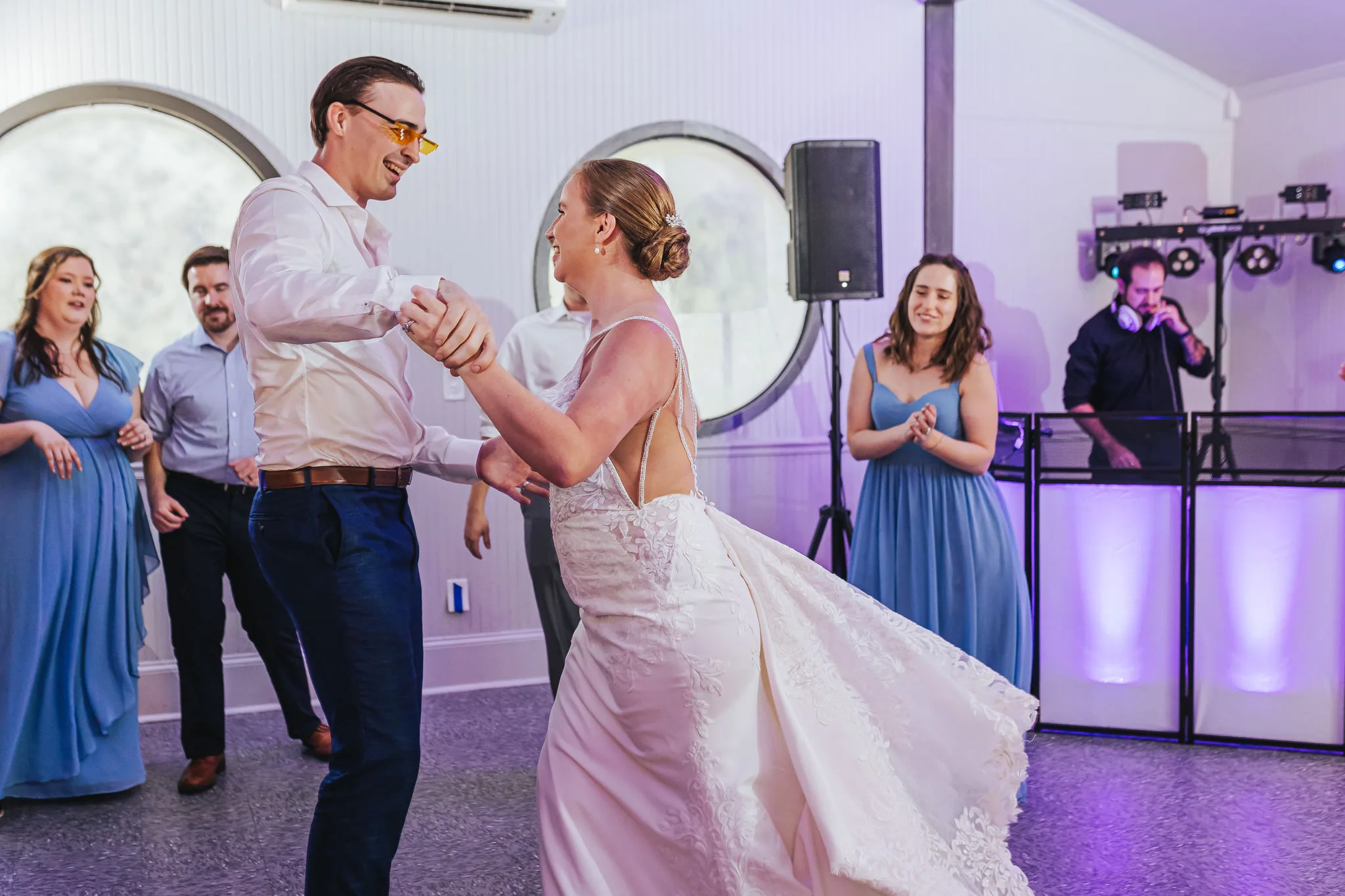 Reception: dancing on the dance floor, the groom in sunglasses, at their wedding at The Wildflower 301 in Greensboro, GA