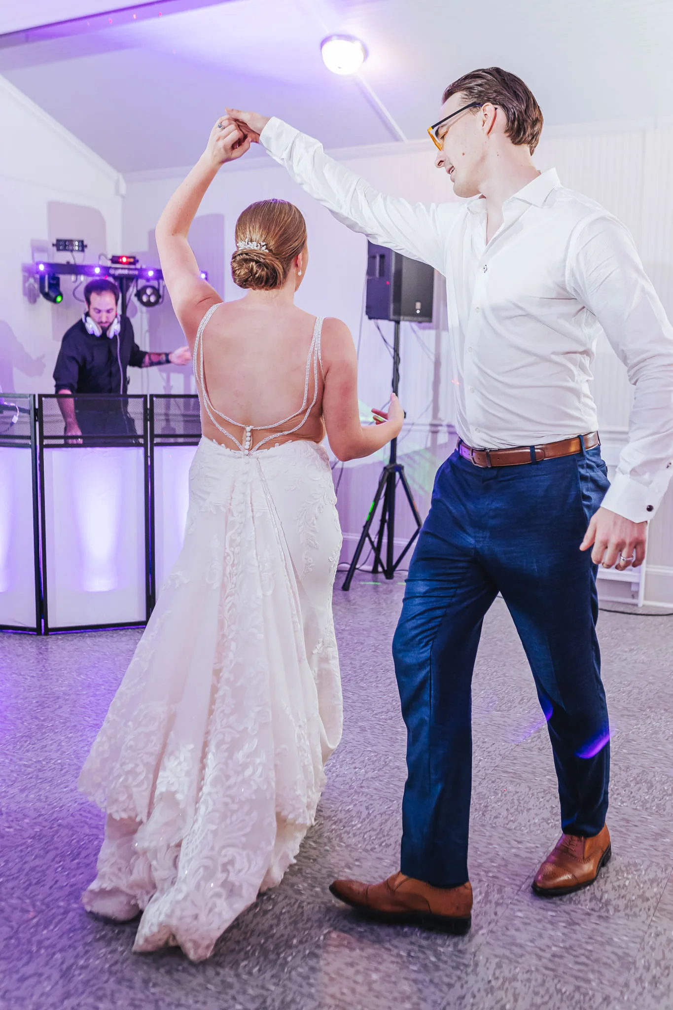Reception: the groom twirling the bride, at their wedding at The Wildflower 301 in Greensboro, GA