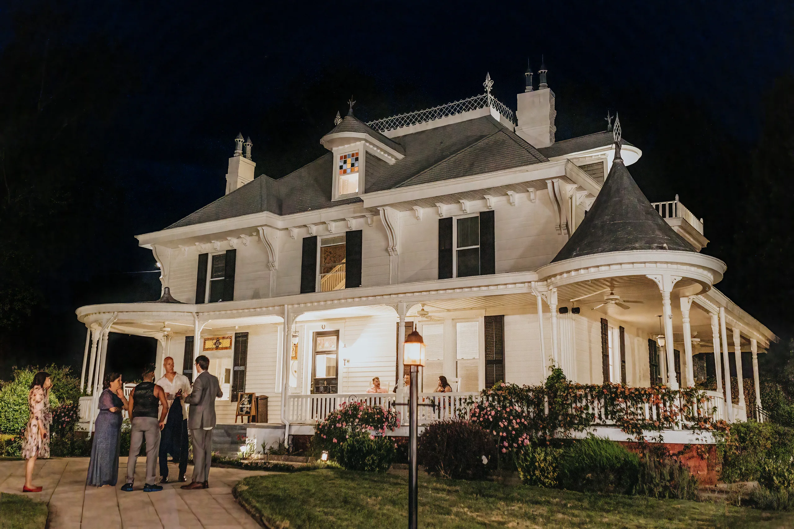 Reception Details: the white mansion lit up at night, at a wedding at The Wildflower 301 in Greensboro, GA