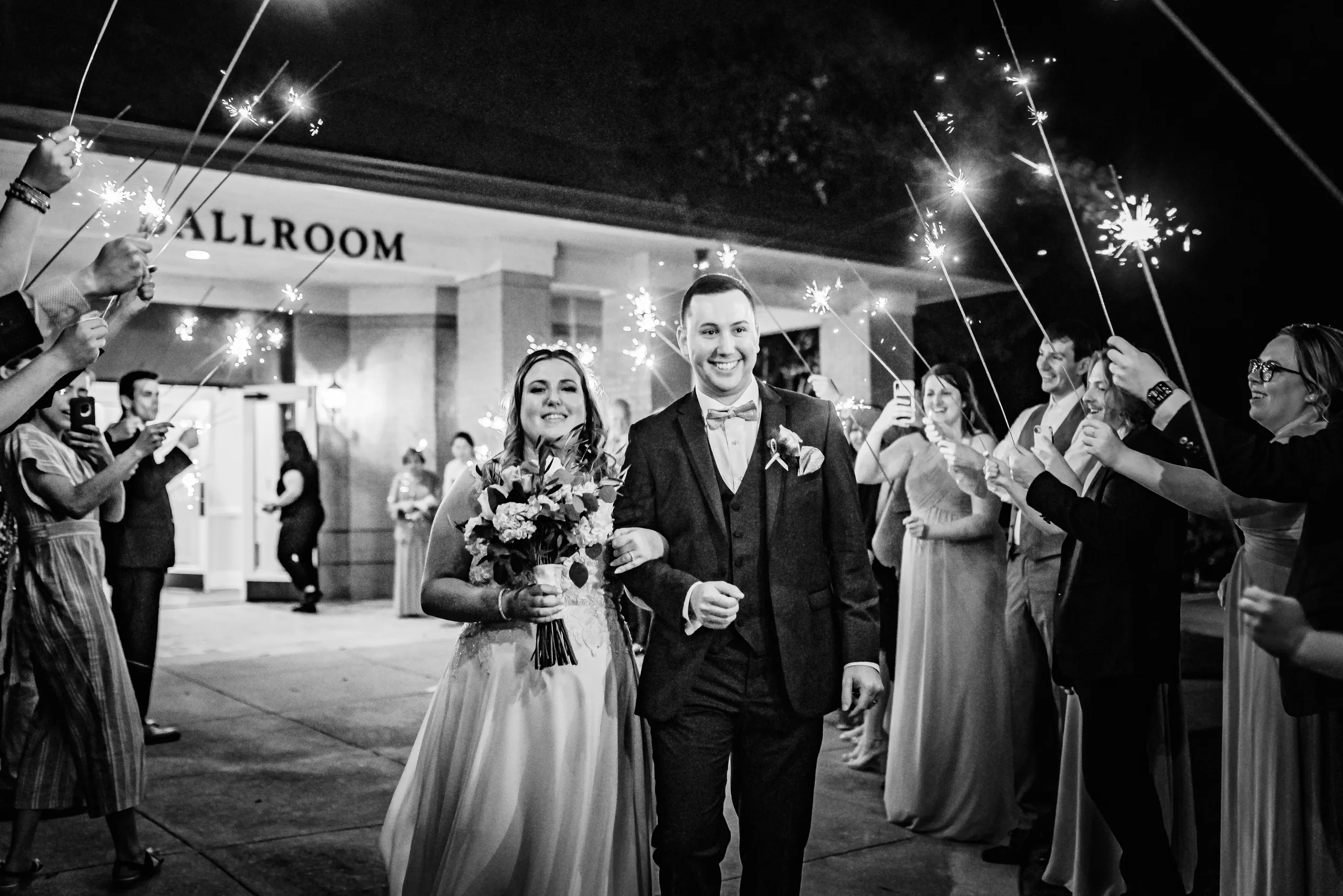 Send-Off: walking out through the sparklers, in black and white at their wedding at the Country Club of Roswell in Roswell, GA