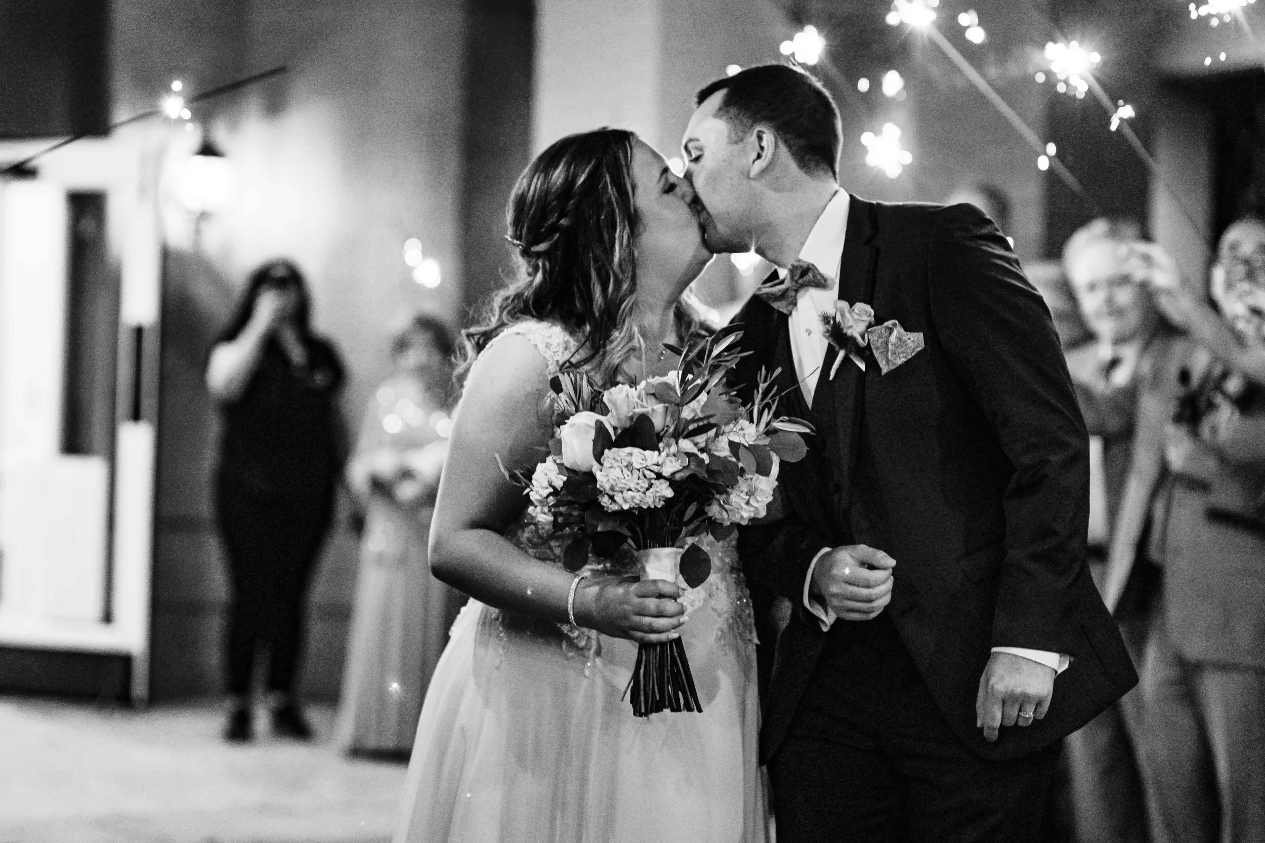 Send-Off: a kiss in the sparklers, in black and white at their wedding at the Country Club of Roswell in Roswell, GA