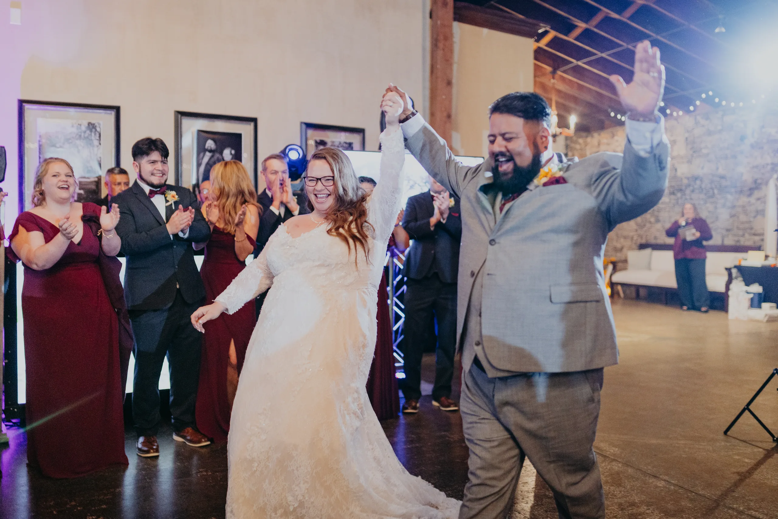 Reception: their grand entrance, hands in the air, at their wedding at 550 Trackside in Lawrenceville, GA