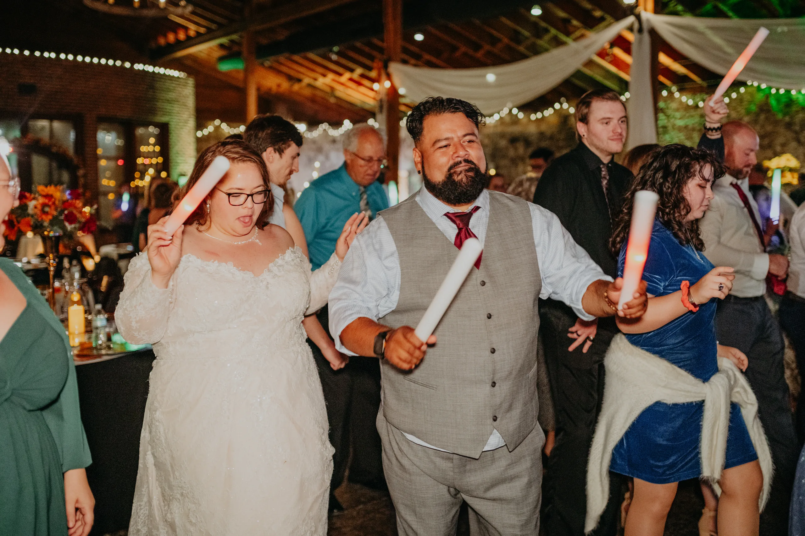 Reception: the couple dancing with light-up wands, at their wedding at 550 Trackside in Lawrenceville, GA