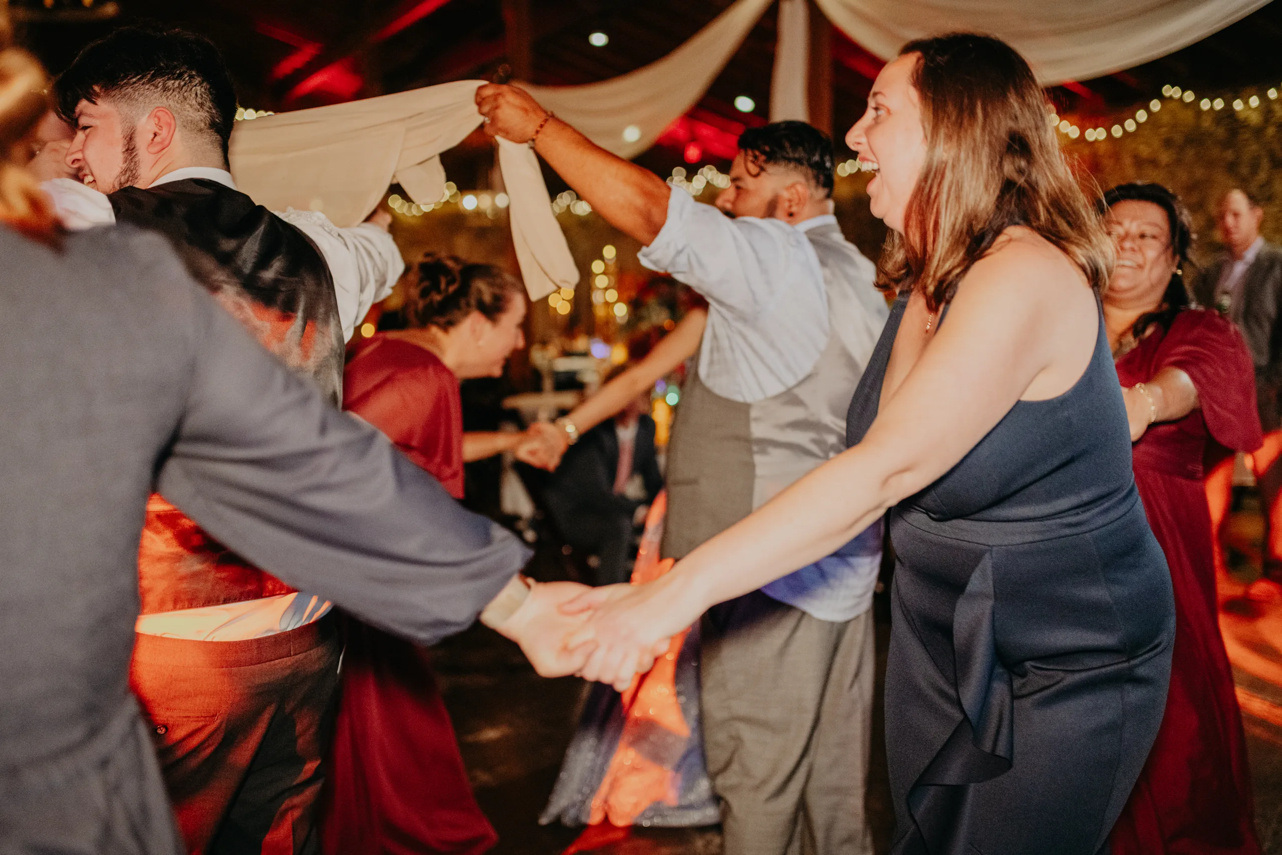 Reception: guests dancing La Víbora de la Mar, at their wedding at 550 Trackside in Lawrenceville, GA