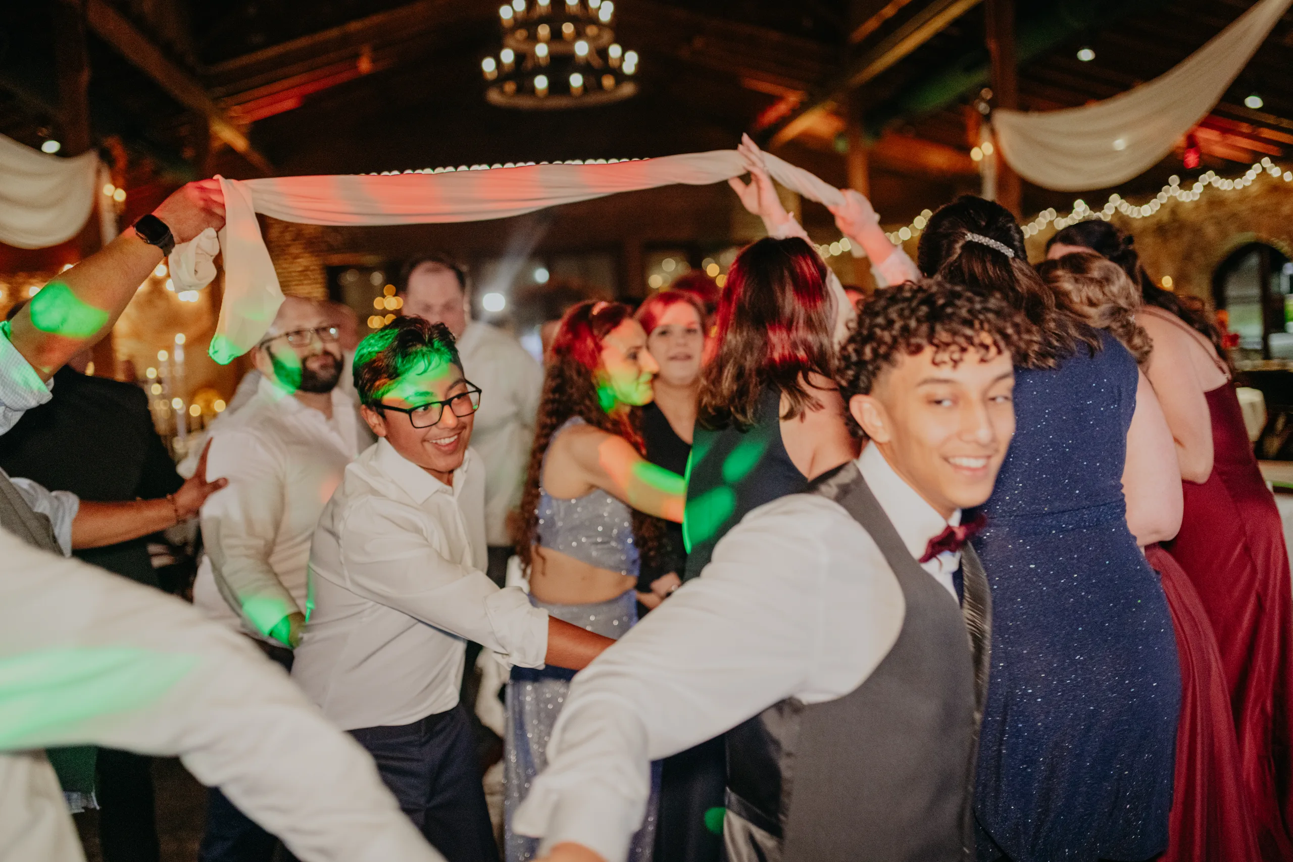 Reception: guests running under the cloth for La Víbora de la Mar, at their wedding at 550 Trackside in Lawrenceville, GA