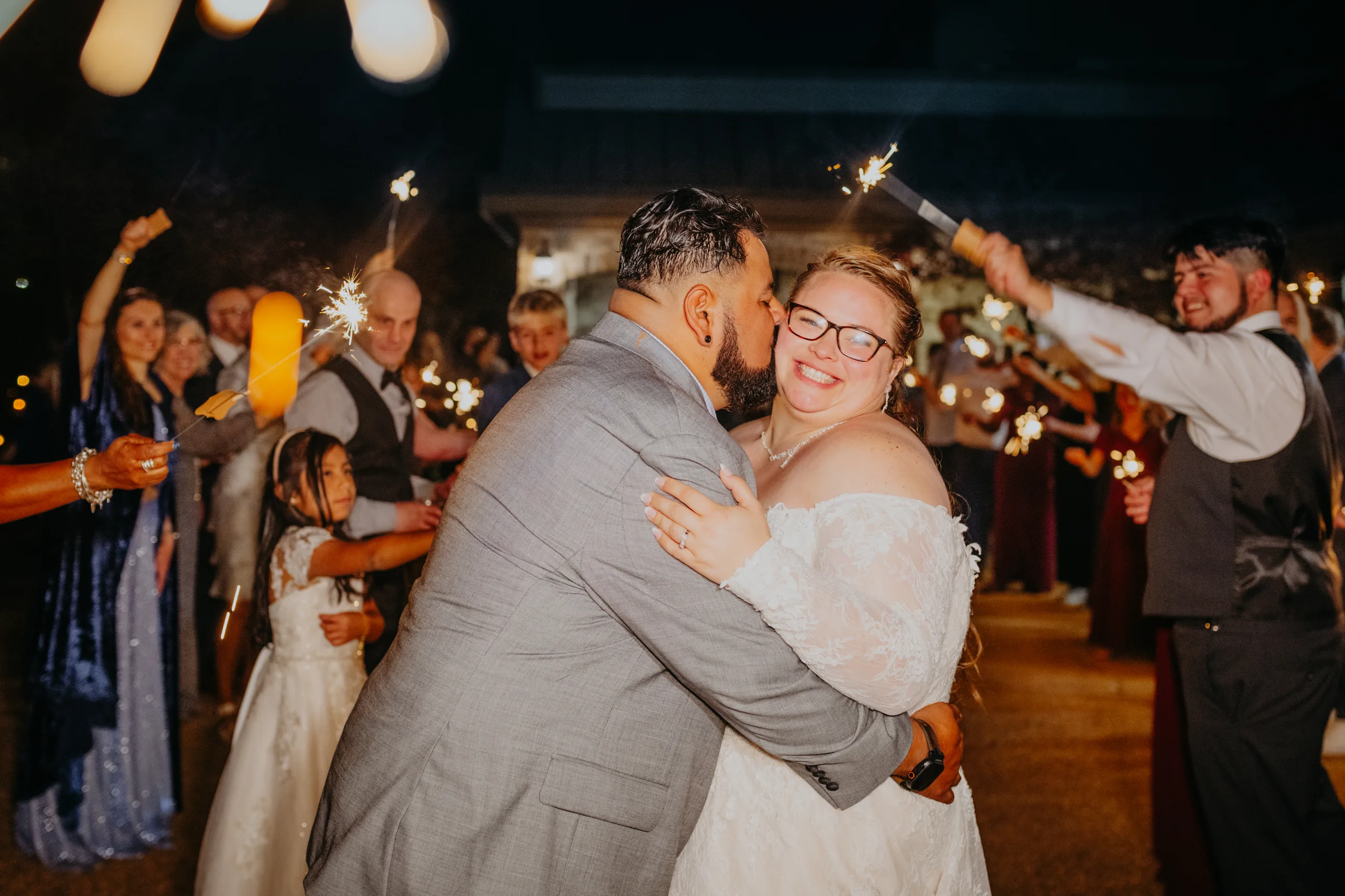Send-Off: a kiss in the middle of the sparklers, at their wedding at 550 Trackside in Lawrenceville, GA