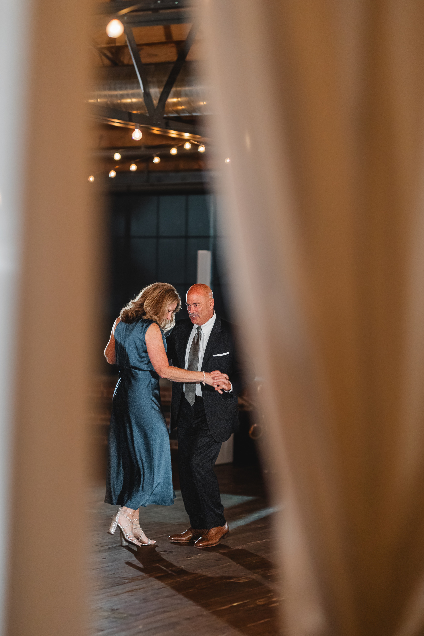 Parent Dance: framed through the draping, at a wedding at Summerour Studio in Atlanta, GA