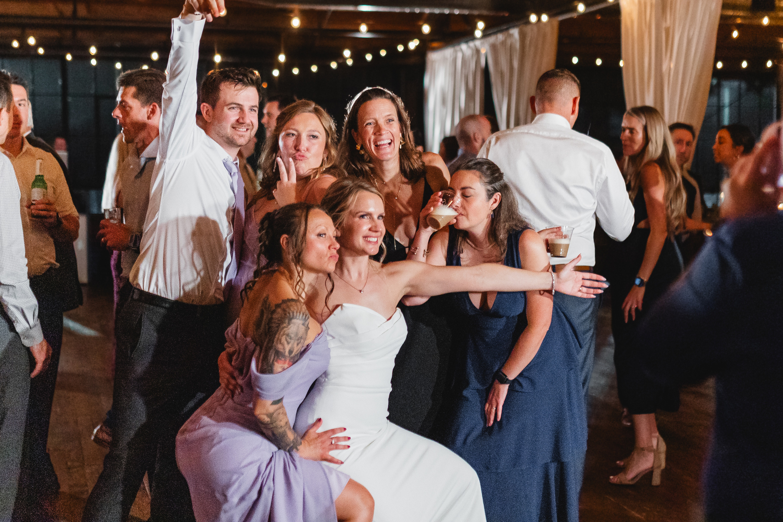 Wedding Reception: the bride and her friends on the dance floor, at their wedding at Summerour Studio in Atlanta, GA