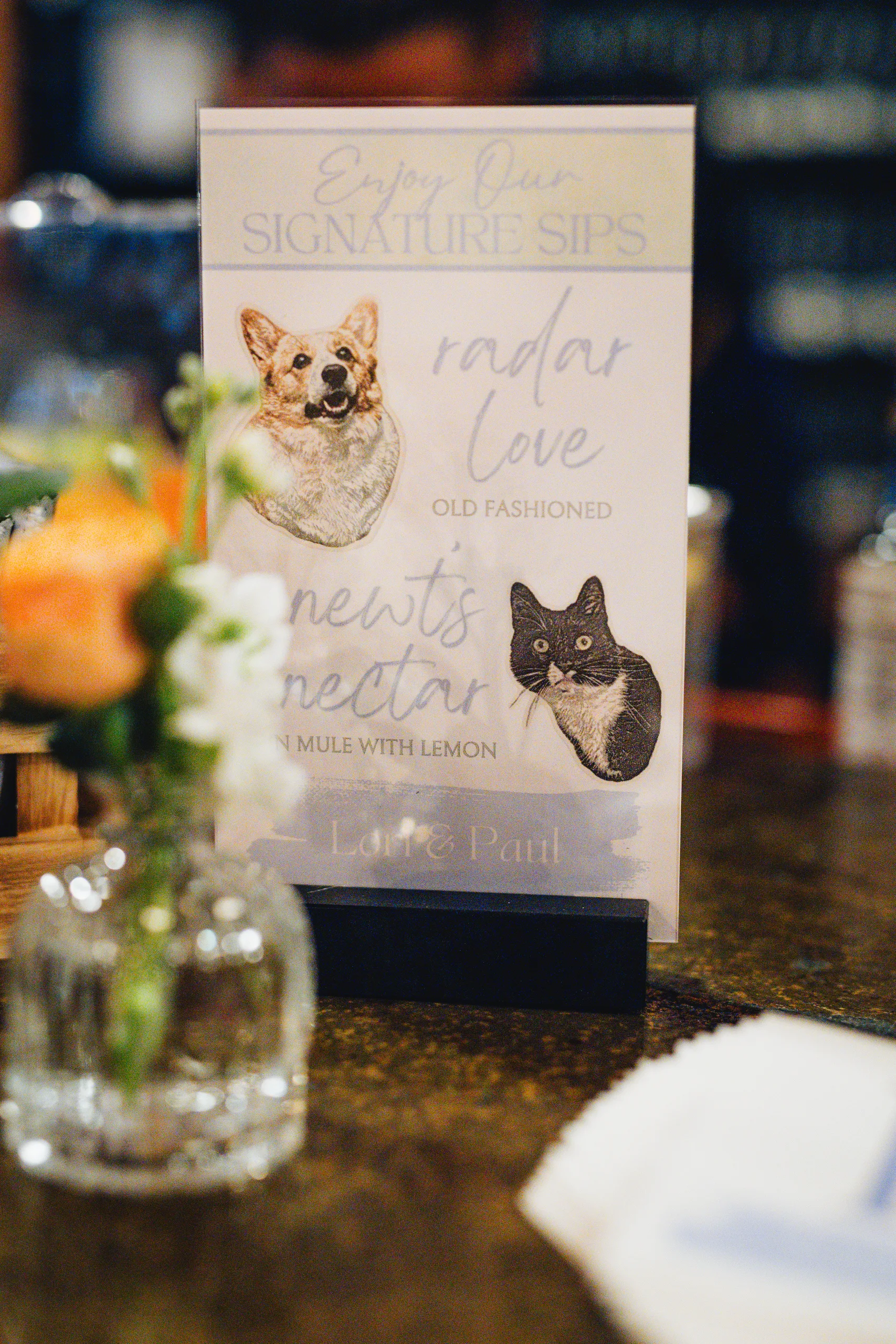 Reception Details: the signature sips sign with their dog and cat at a wedding at Ivy Hall at Roswell Mill in Roswell, GA