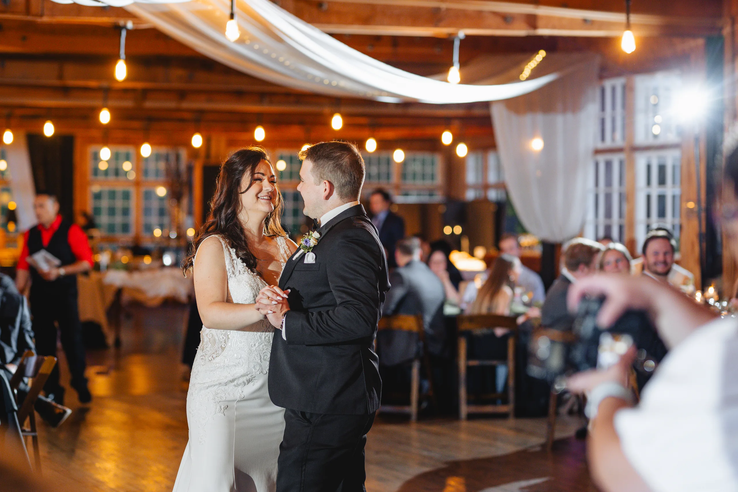 First Dance: their first dance under the string lights at their wedding at Ivy Hall at Roswell Mill in Roswell, GA