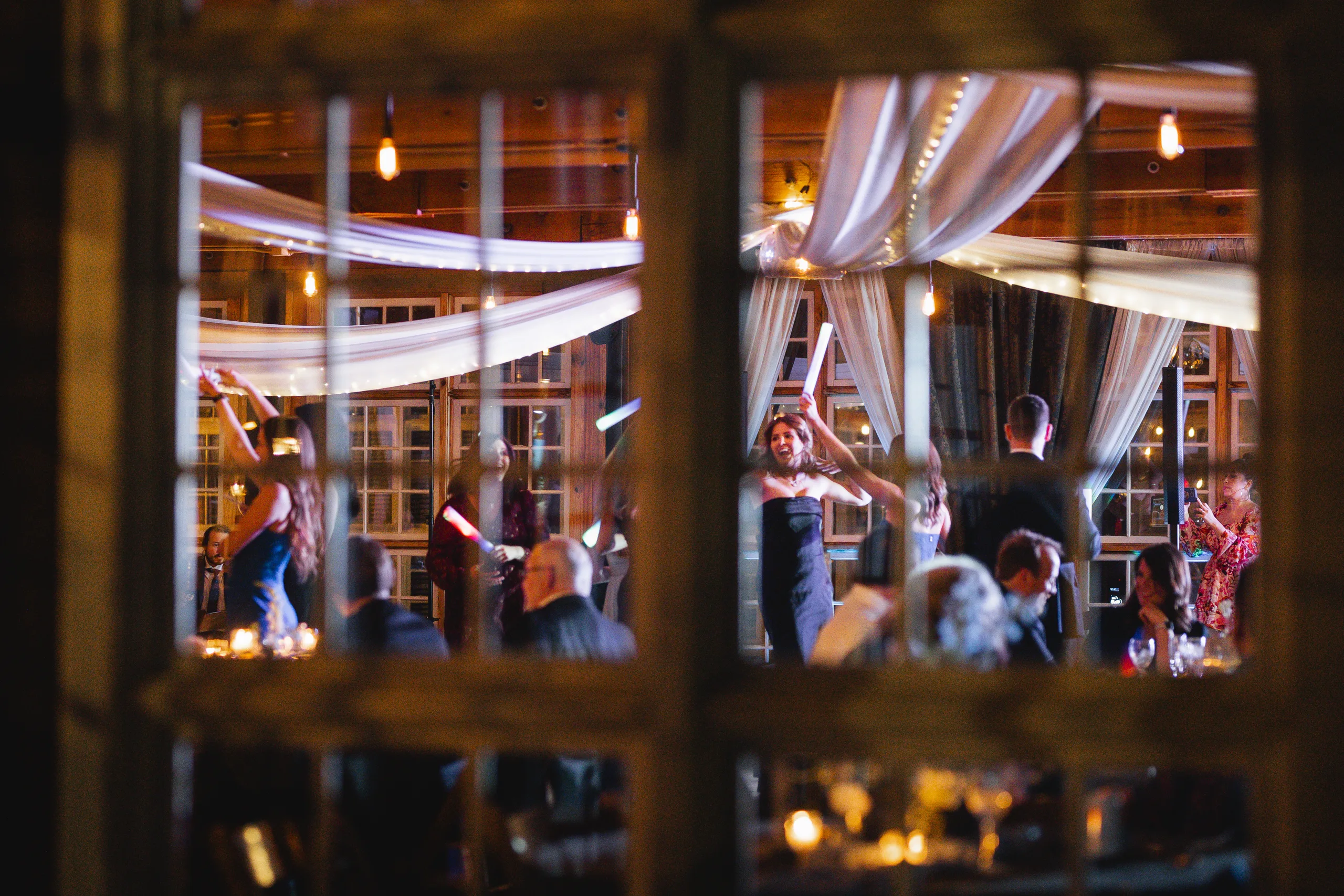 Reception: the dance floor seen through the old windows at their wedding at Ivy Hall at Roswell Mill in Roswell, GA