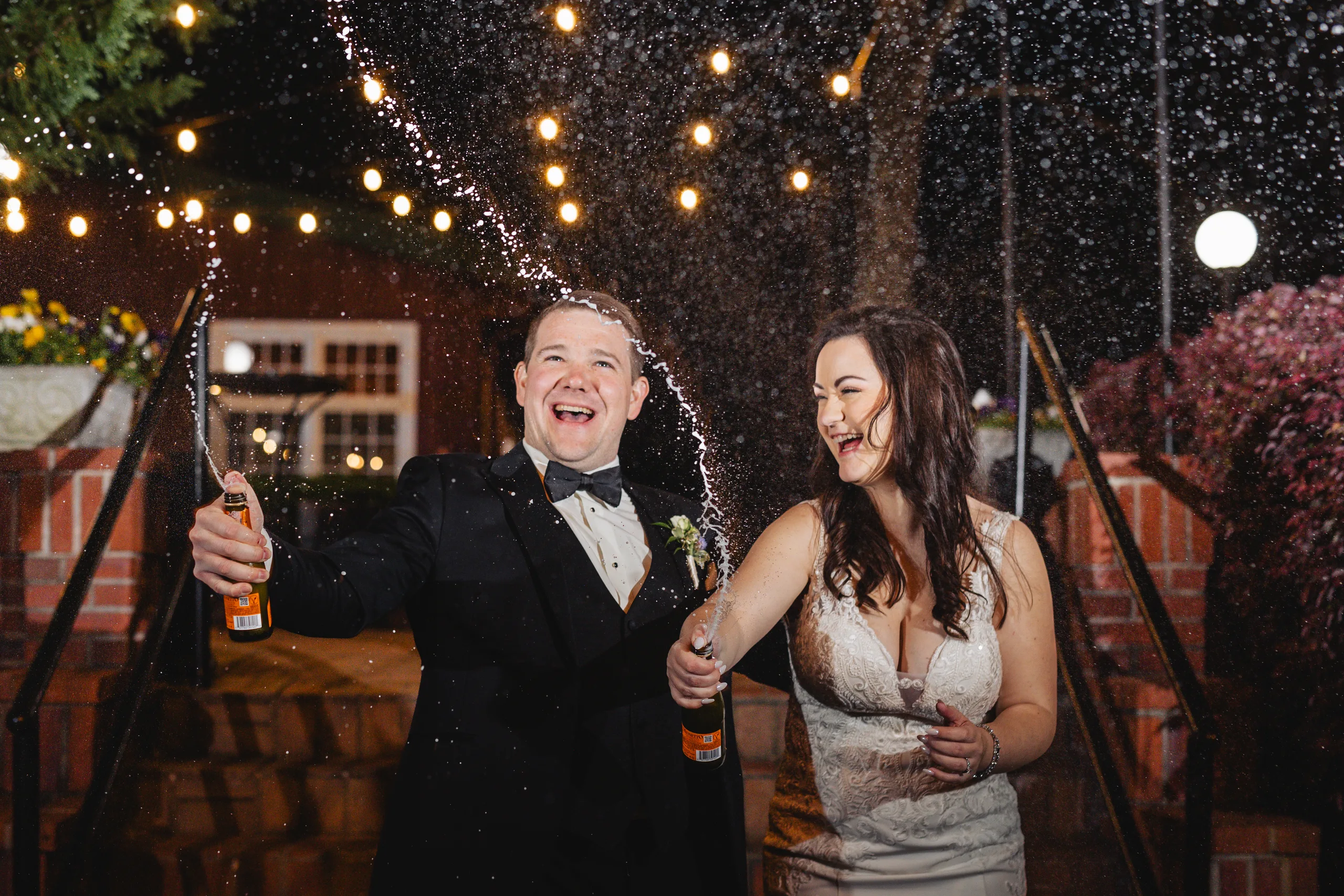 Send-Off: spraying champagne on their way out at their wedding at Ivy Hall at Roswell Mill in Roswell, GA