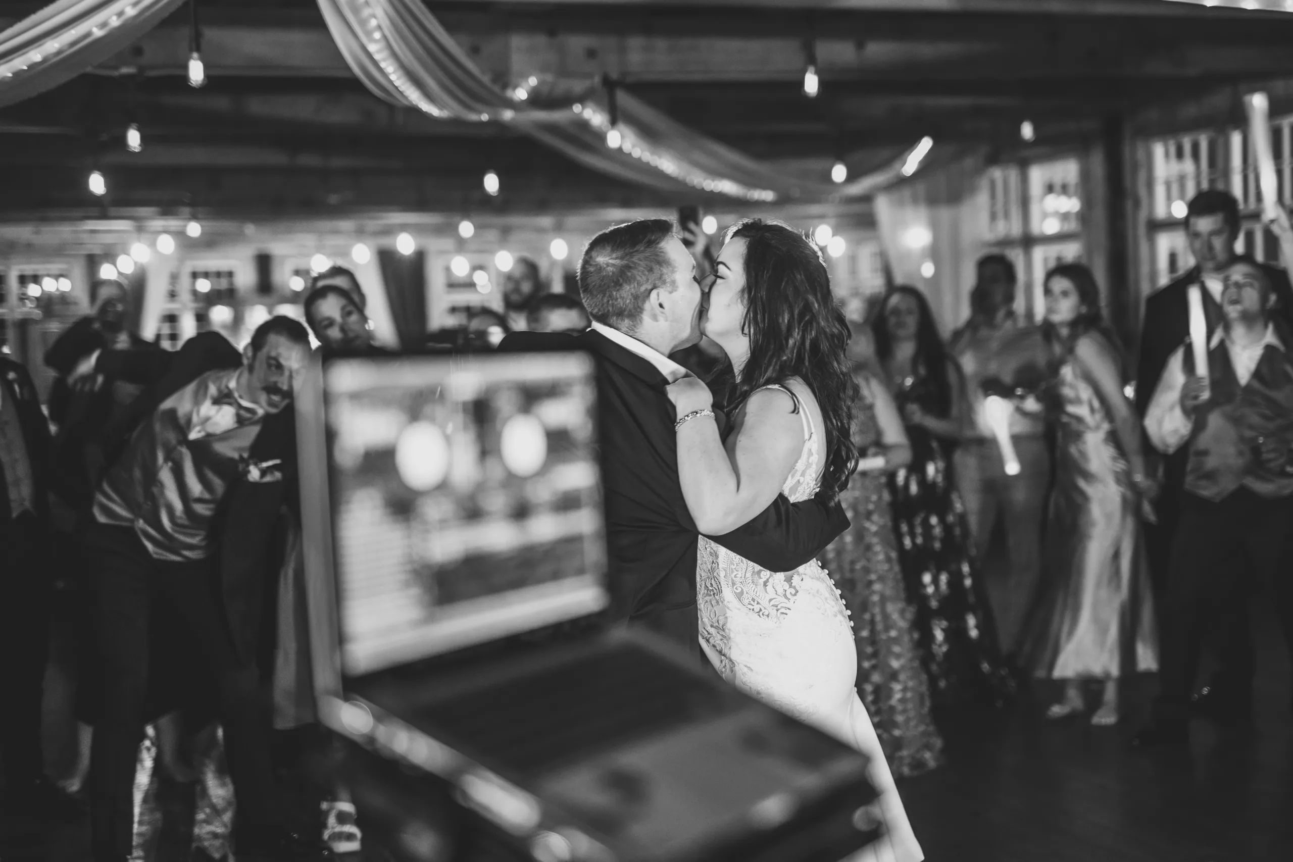 Reception: a kiss on the dance floor, in black and white at their wedding at Ivy Hall at Roswell Mill in Roswell, GA
