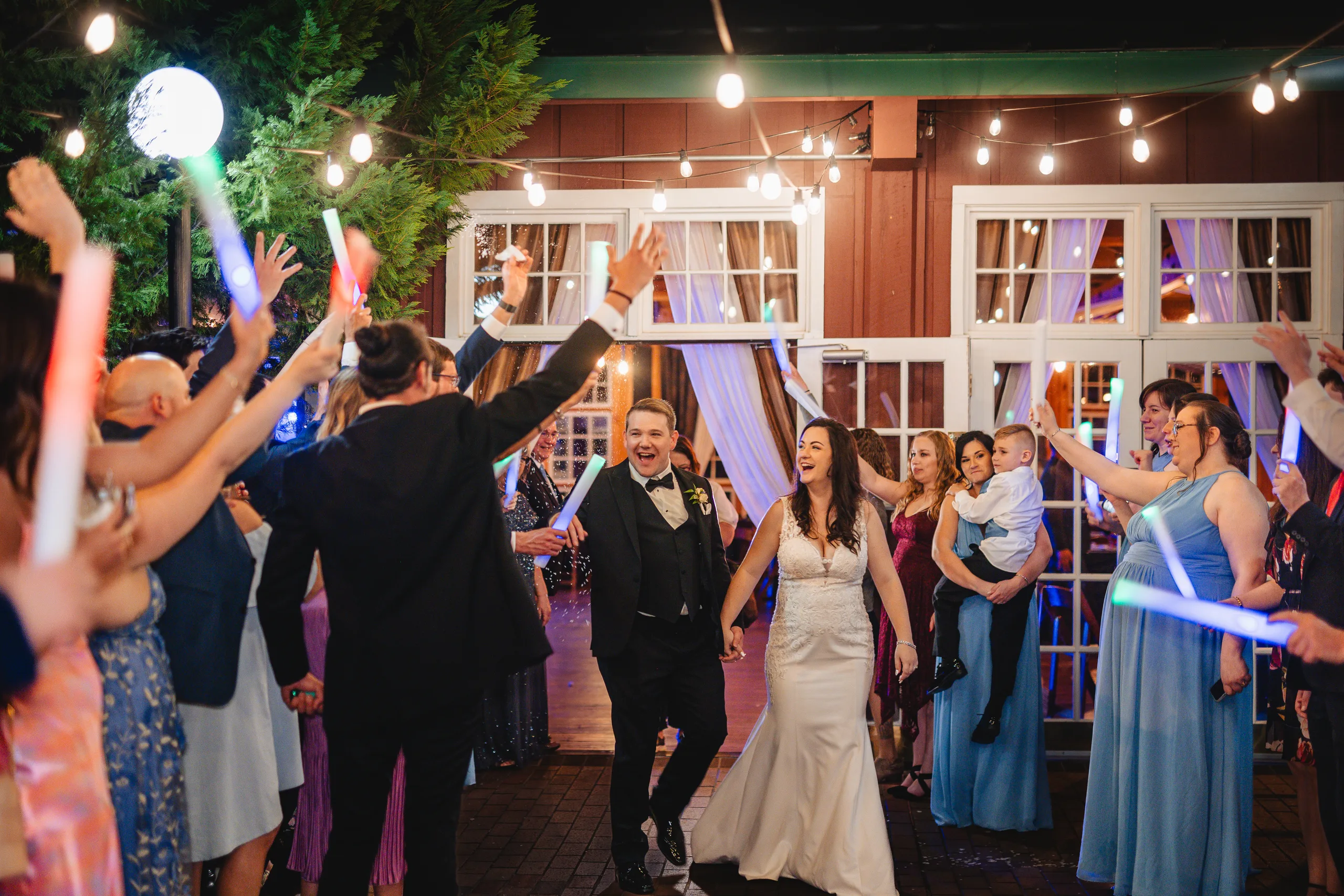 Reception: dancing through the guests with light-up wands at their wedding at Ivy Hall at Roswell Mill in Roswell, GA