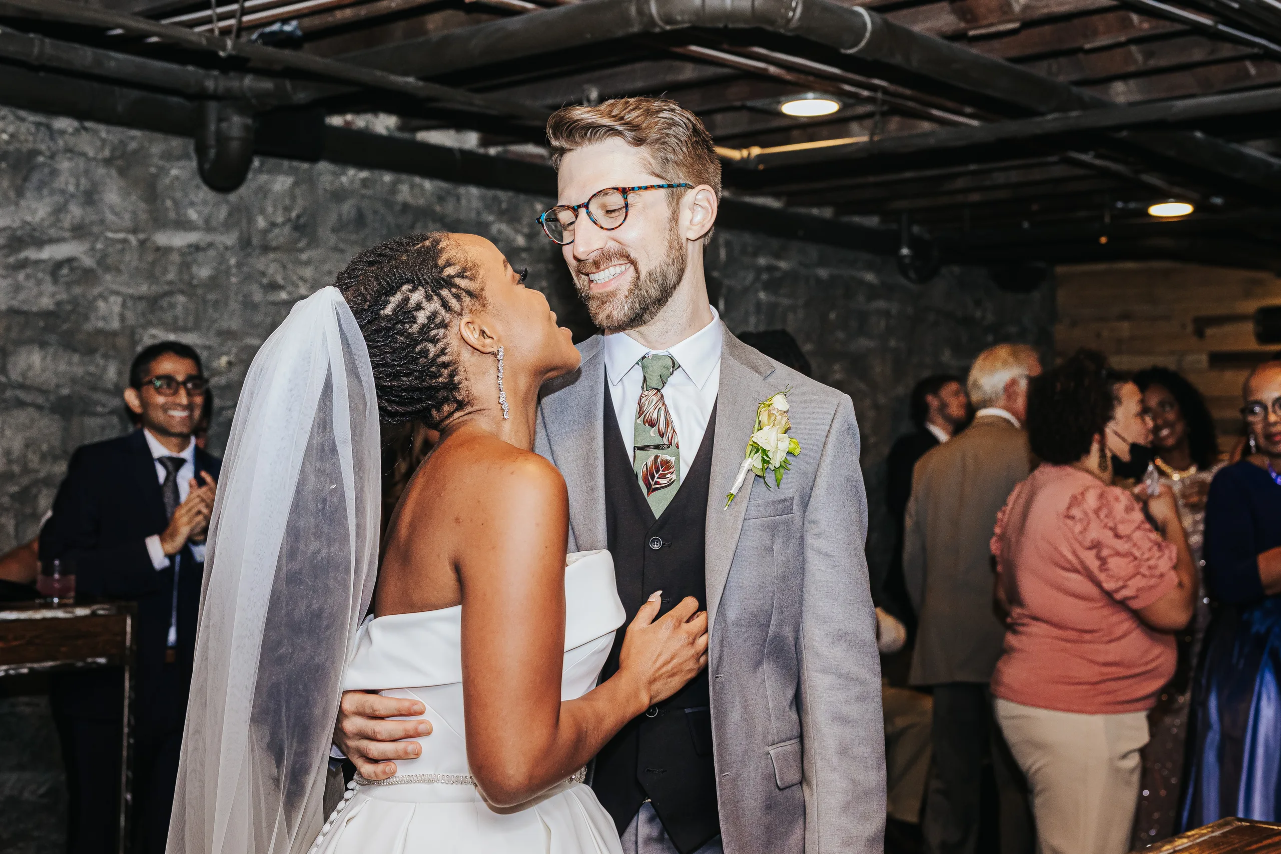 Reception: laughing together in the stone cellar, at their wedding at Terminus 330 in Atlanta, GA