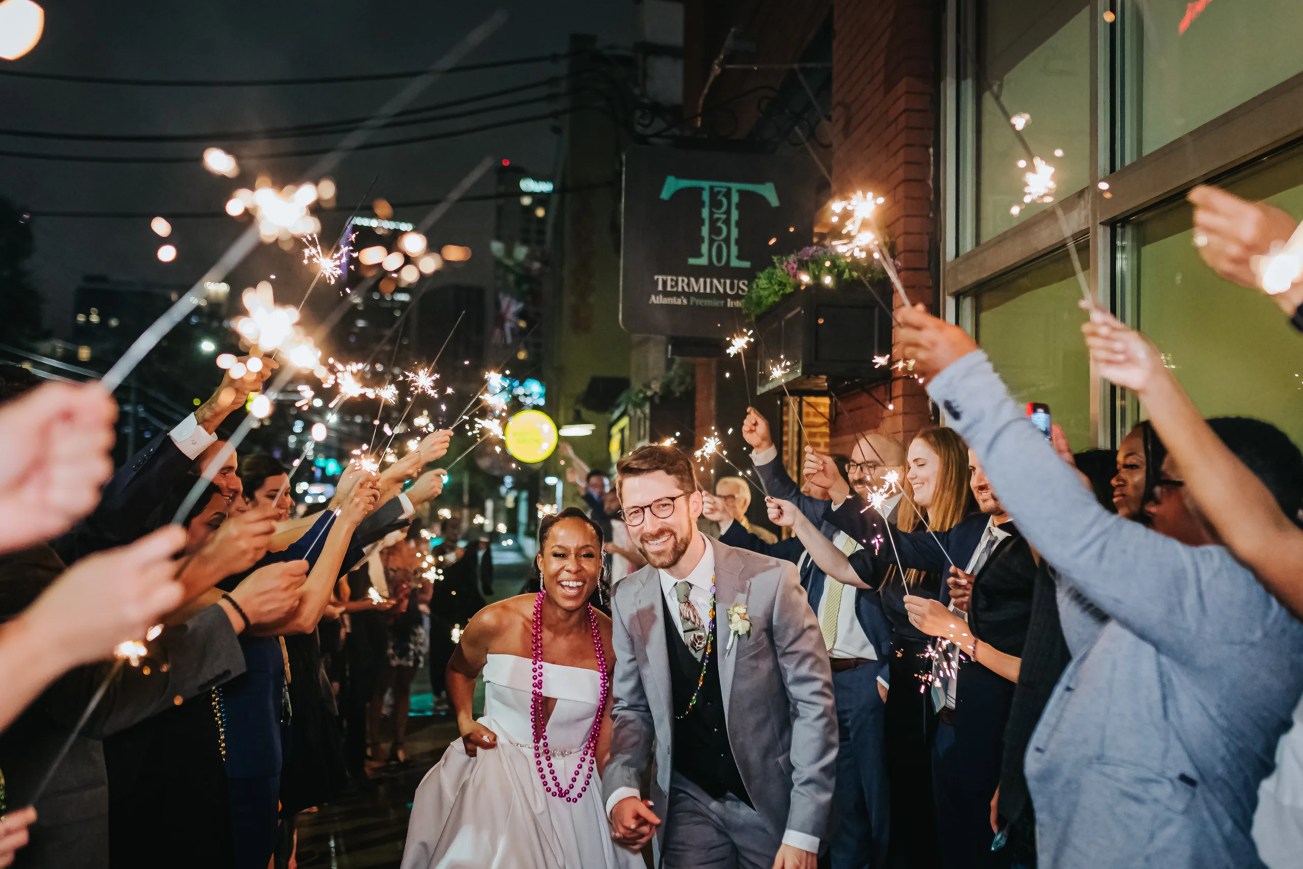 Send-Off: running out under the Terminus 330 sign through the sparklers, at their wedding at Terminus 330 in Atlanta, GA