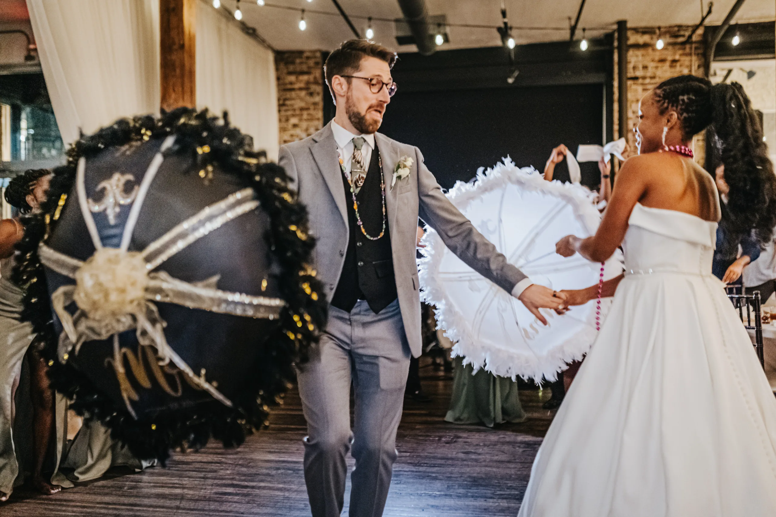 Reception: the second line with a black and a white parasol, at their wedding at Terminus 330 in Atlanta, GA
