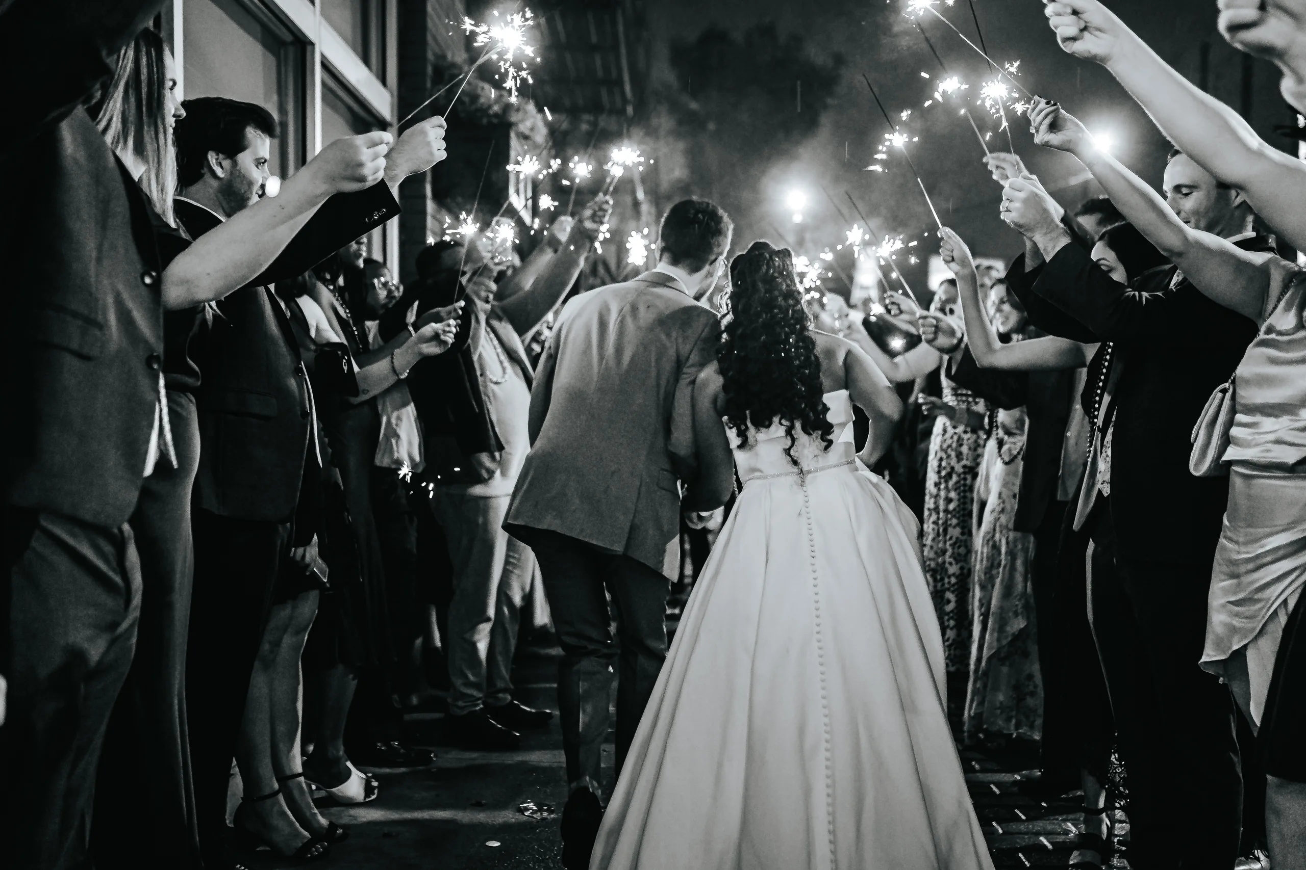 Send-Off: walking out through the sparklers, in black and white, at their wedding at Terminus 330 in Atlanta, GA