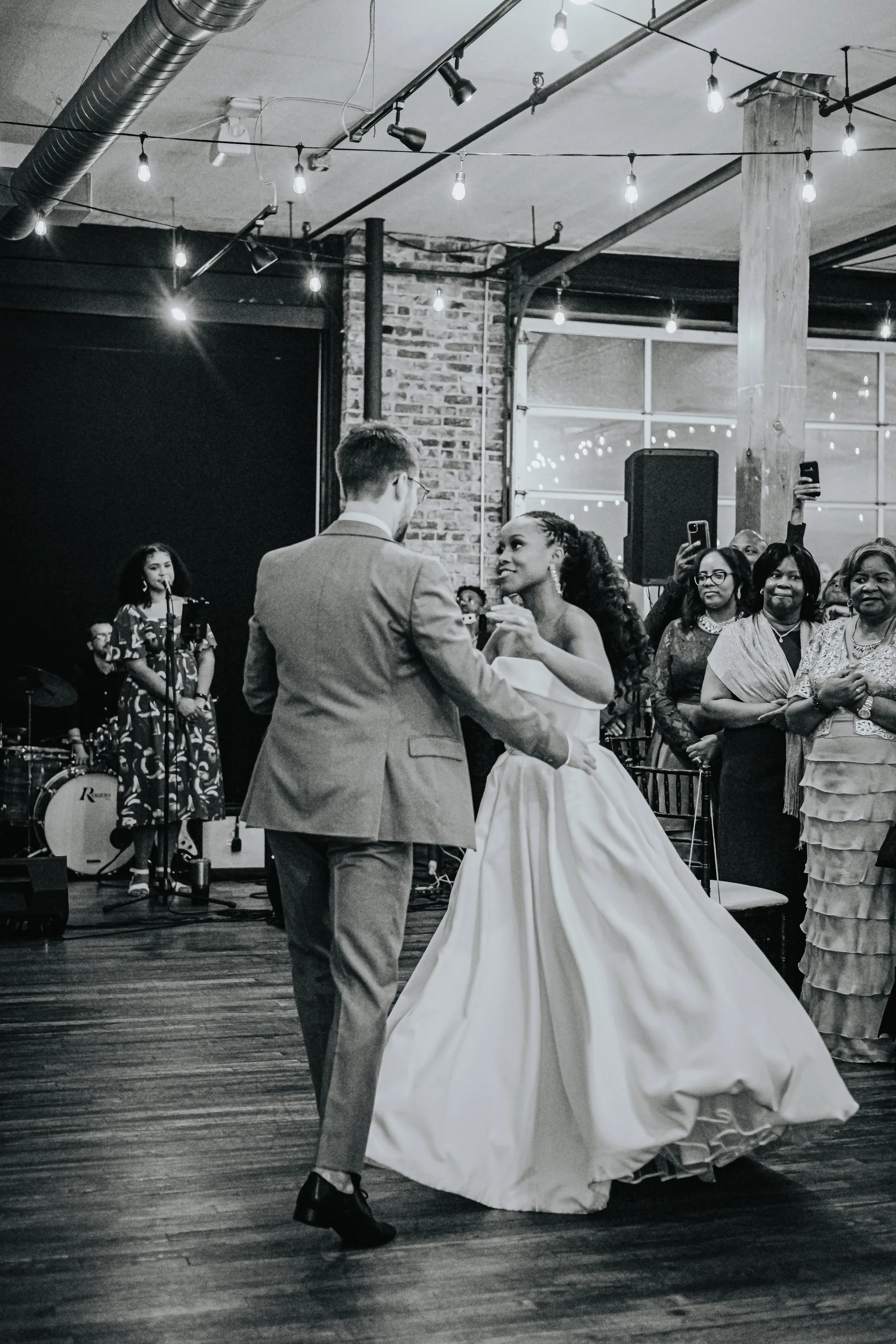 First Dance: dancing as their guests watch, in black and white, at their wedding at Terminus 330 in Atlanta, GA