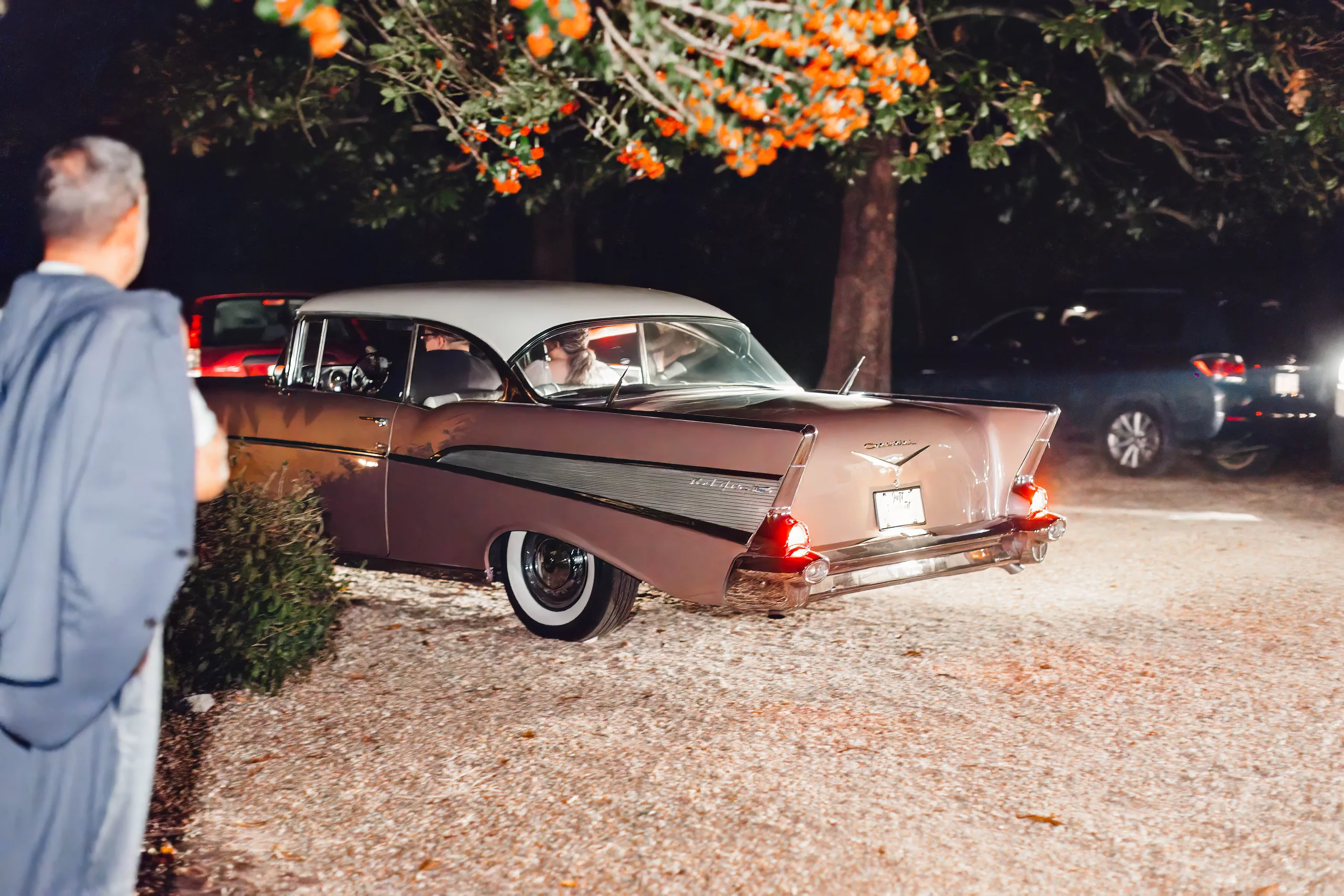 Send-Off: the pink Chevrolet pulling away at night, at their wedding at Naylor Hall in Roswell, GA