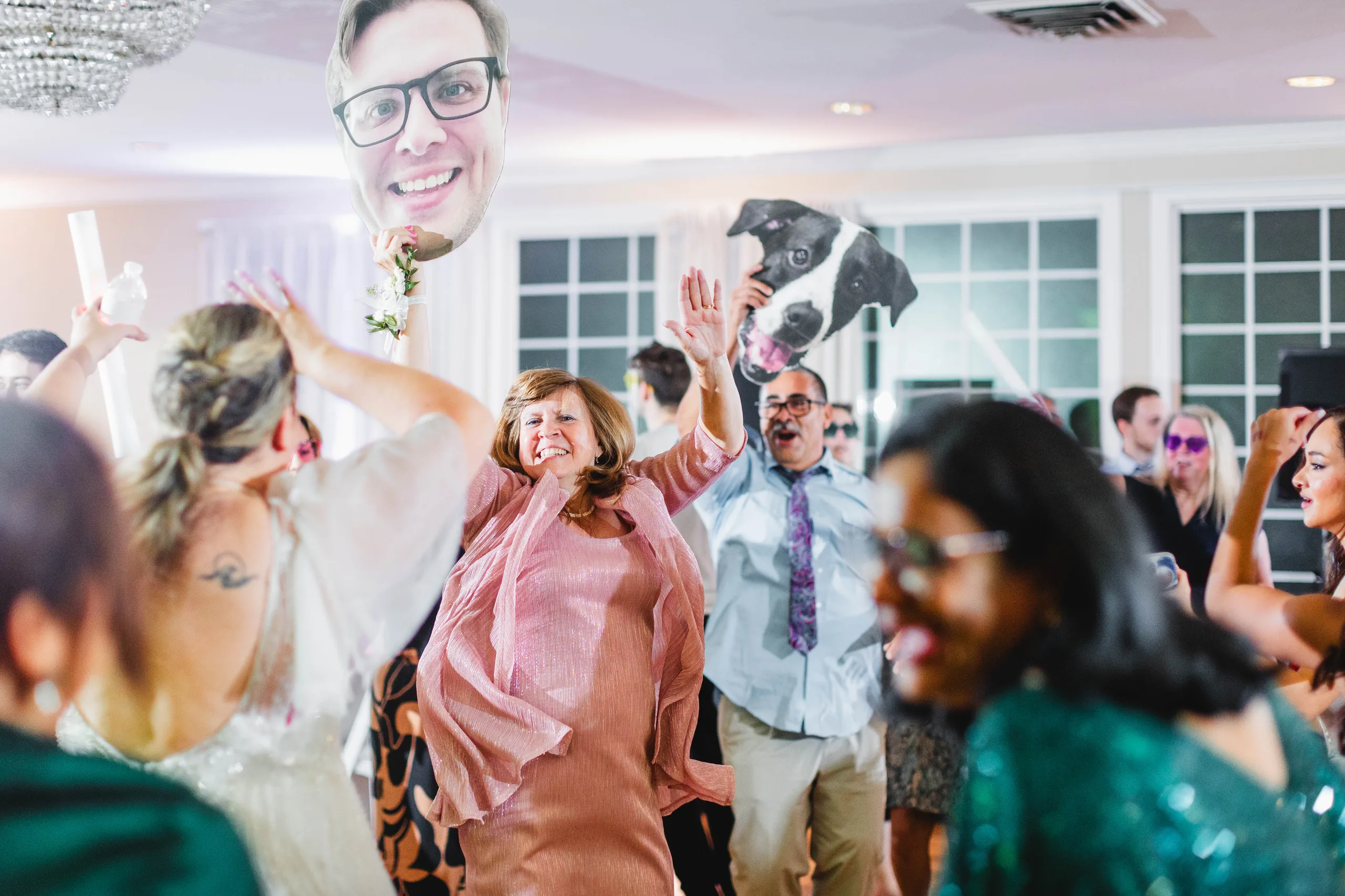 Reception: dancing under giant cutouts of the groom's face and their dog, at their wedding at Naylor Hall in Roswell, GA