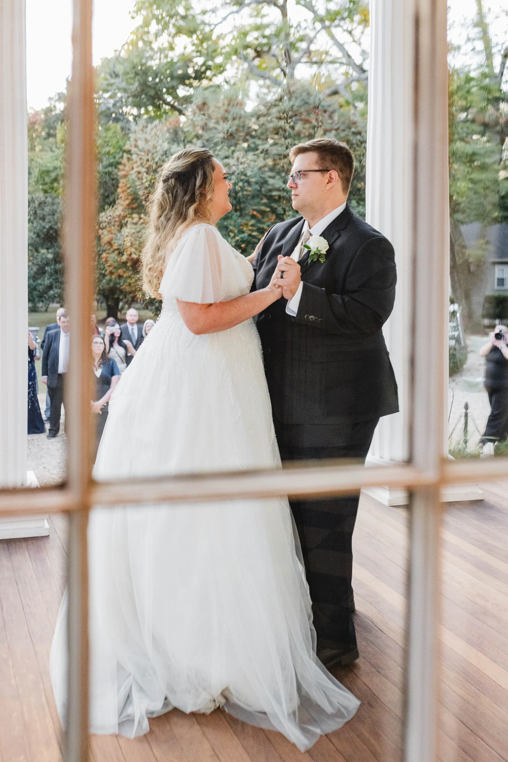 First Dance: seen through the window panes on the porch, at their wedding at Naylor Hall in Roswell, GA