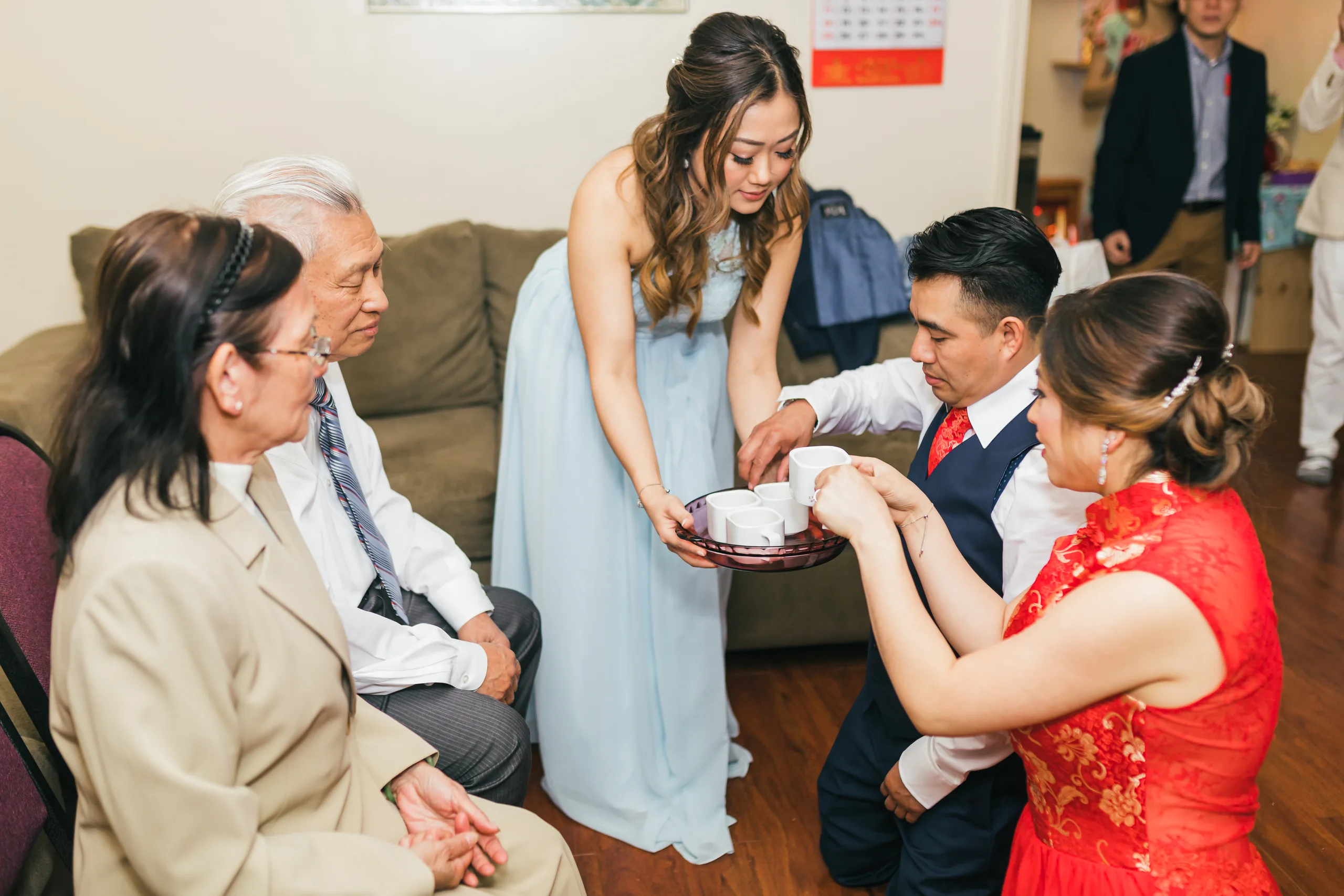 Tea Ceremony: a bridesmaid in blue helping the couple serve tea to family before their wedding at the Payne-Corley House in Duluth, GA