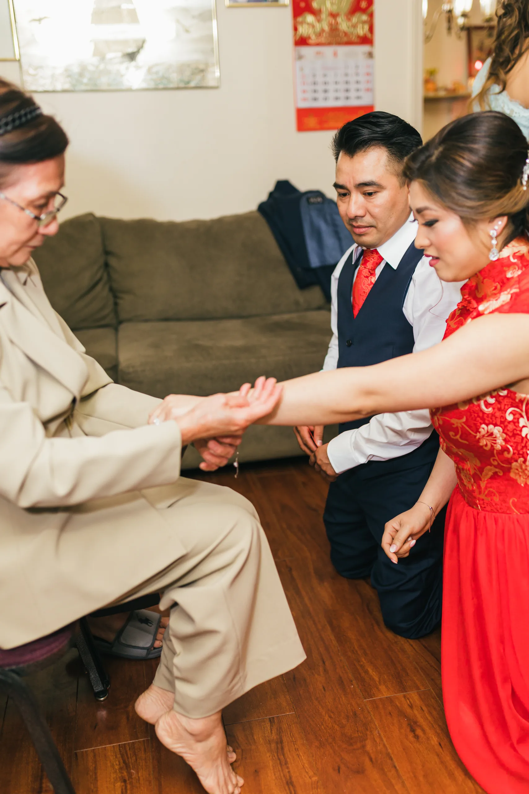 Tea Ceremony: a family member placing a bracelet on the bride before their wedding at the Payne-Corley House in Duluth, GA