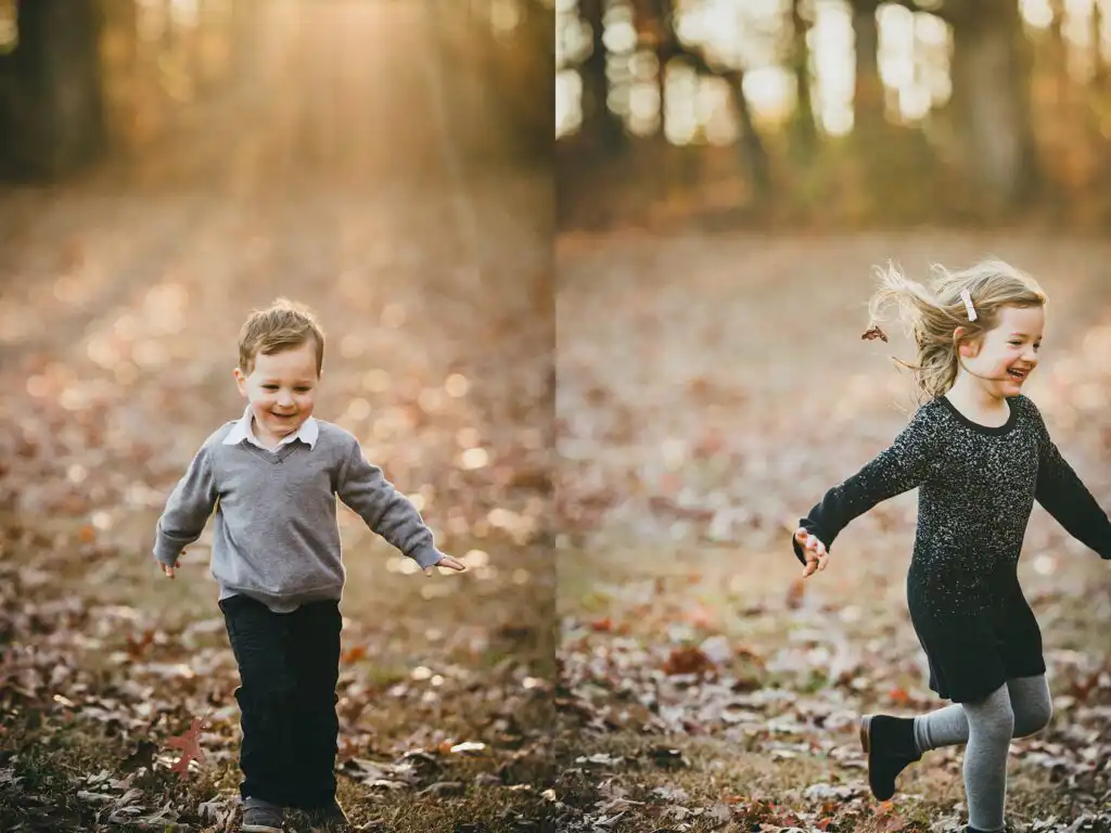 Two young children running through fallen leaves at a family session at Leita Thompson Memorial Park in Roswell, Georgia