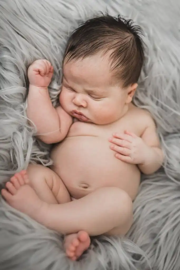 Sleeping newborn on soft fur during an at-home newborn session with an Atlanta portrait photographer