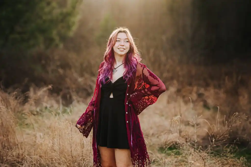High school senior portrait session in a field at Garrard Landing Park, Roswell, by an Atlanta portrait photographer